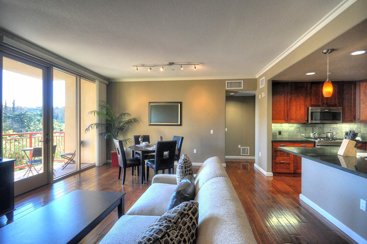 a view of a living room filled with furniture and a large window