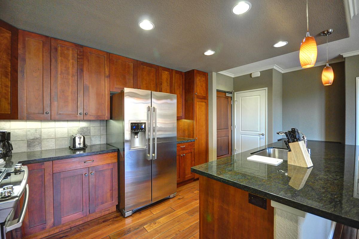 a large kitchen with stainless steel appliances