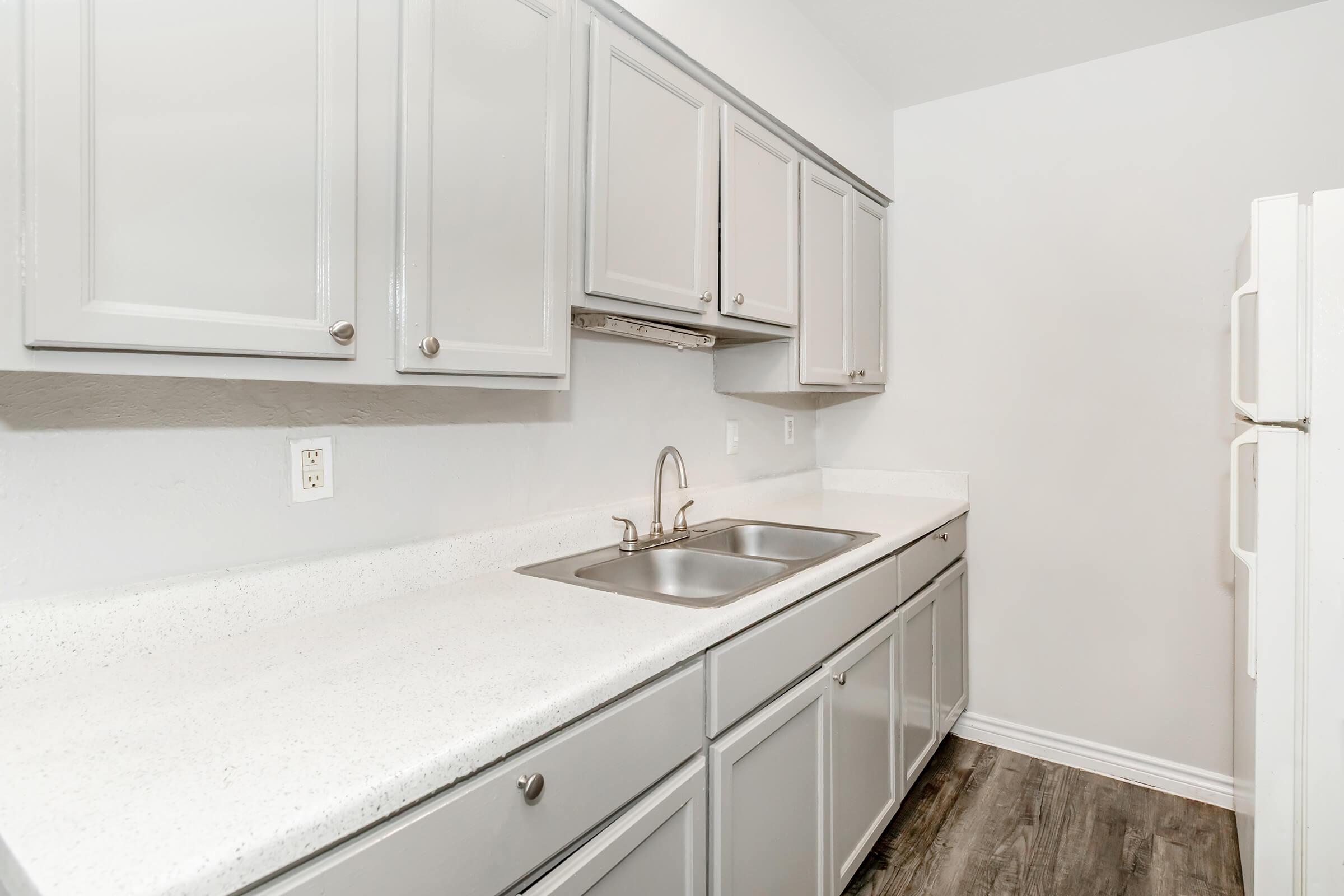 a kitchen with a sink and a mirror