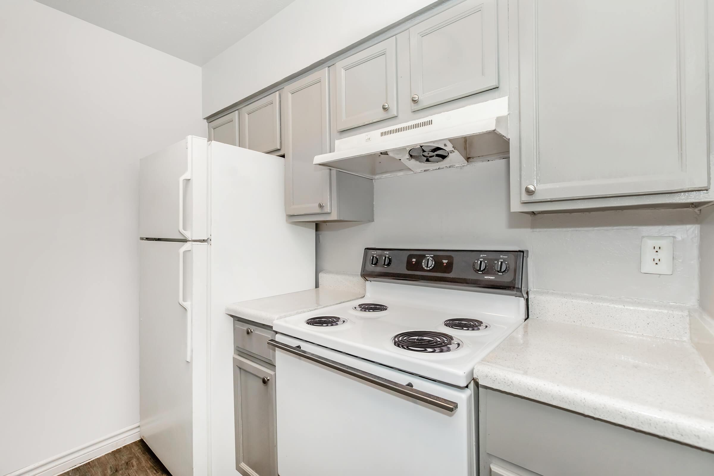 a kitchen with a stove sink and refrigerator