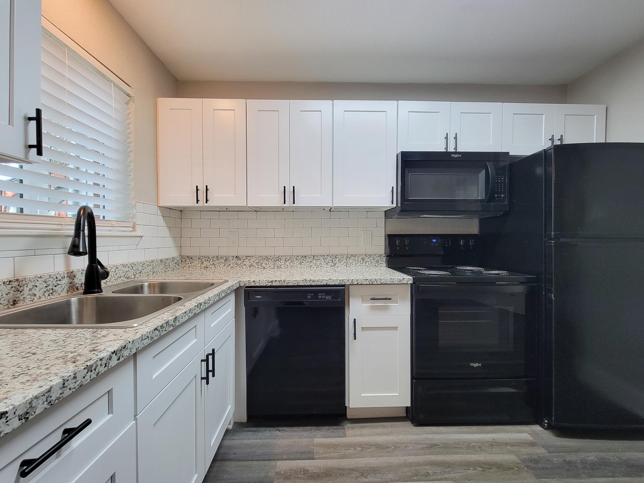 a large kitchen with stainless steel appliances