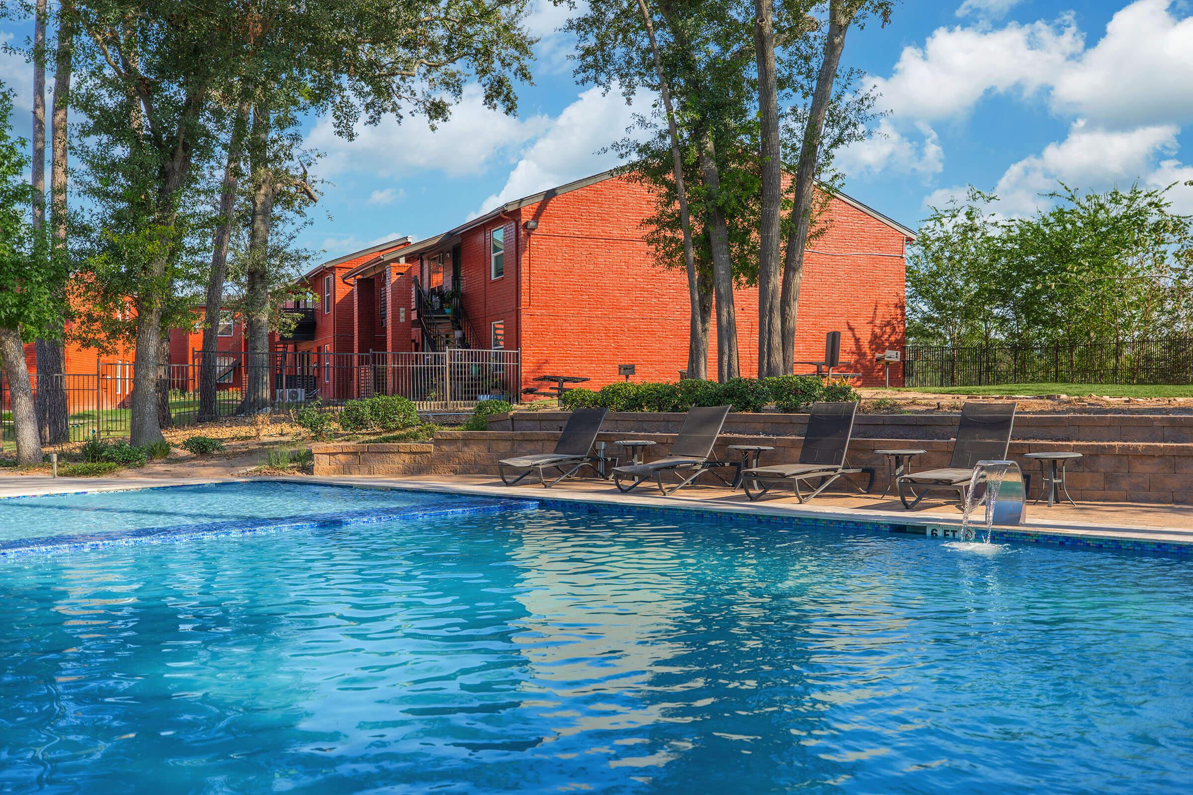 a large pool of water in front of a house