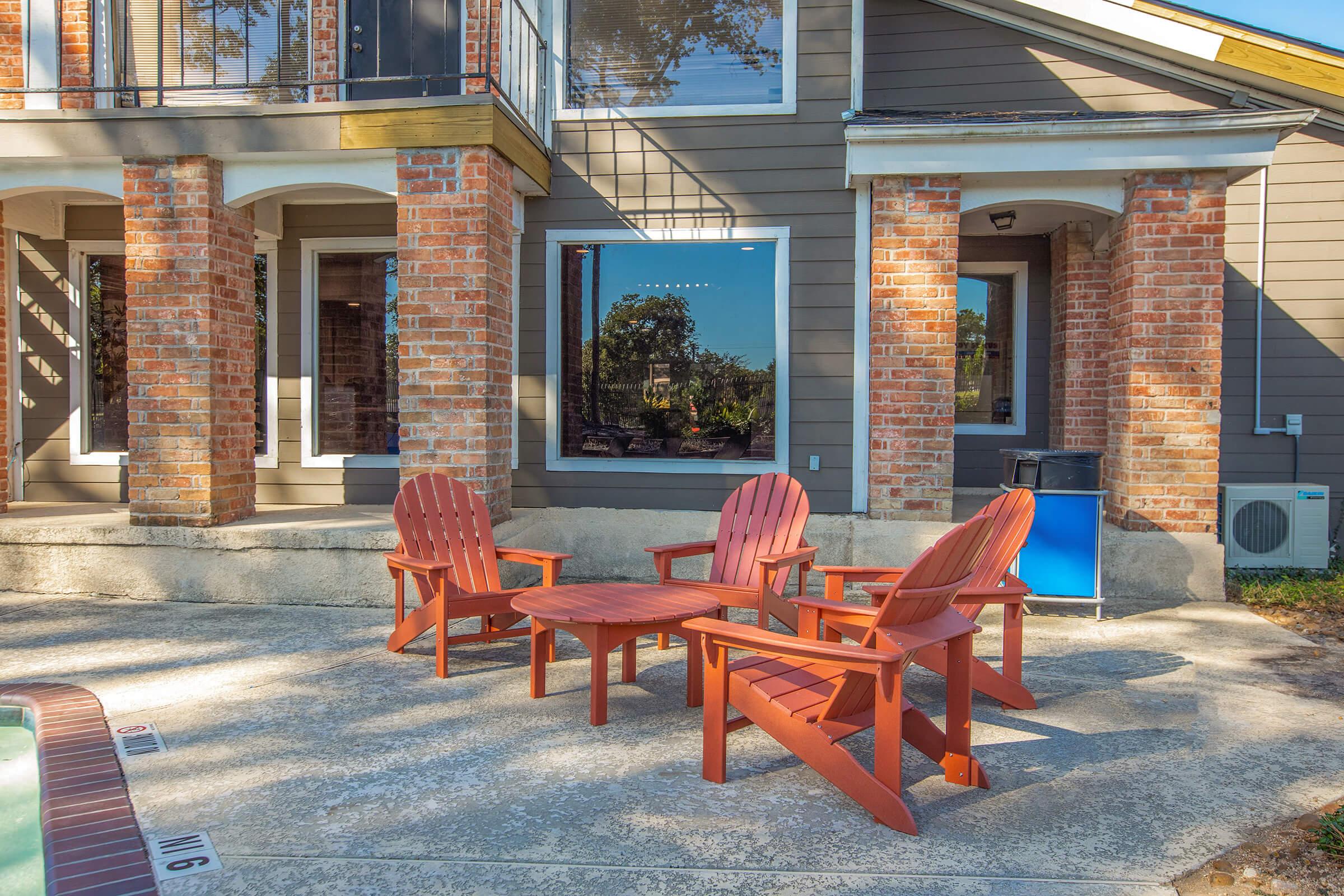 a fire place sitting in a chair in front of a brick building