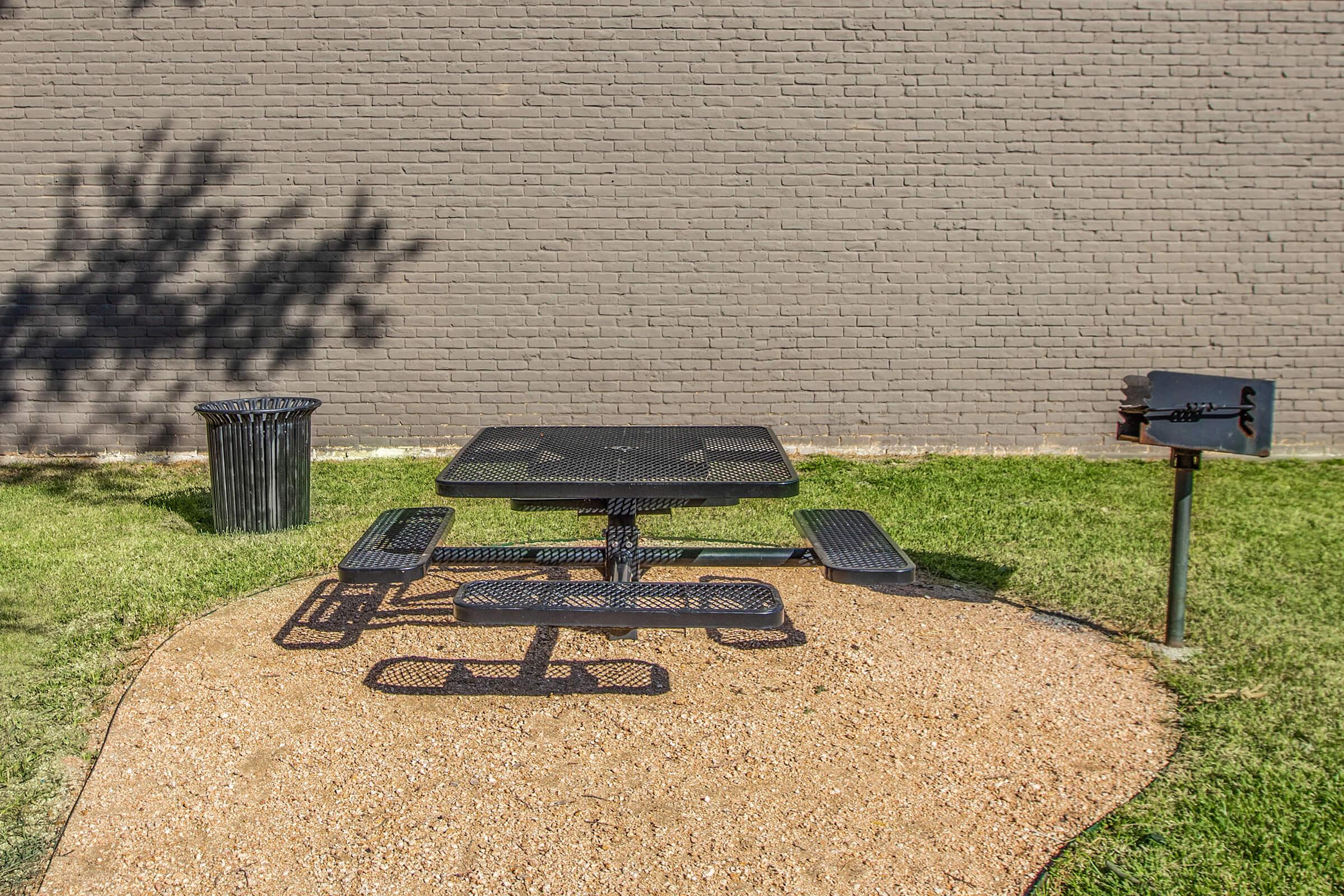 an empty park bench sitting in front of a building