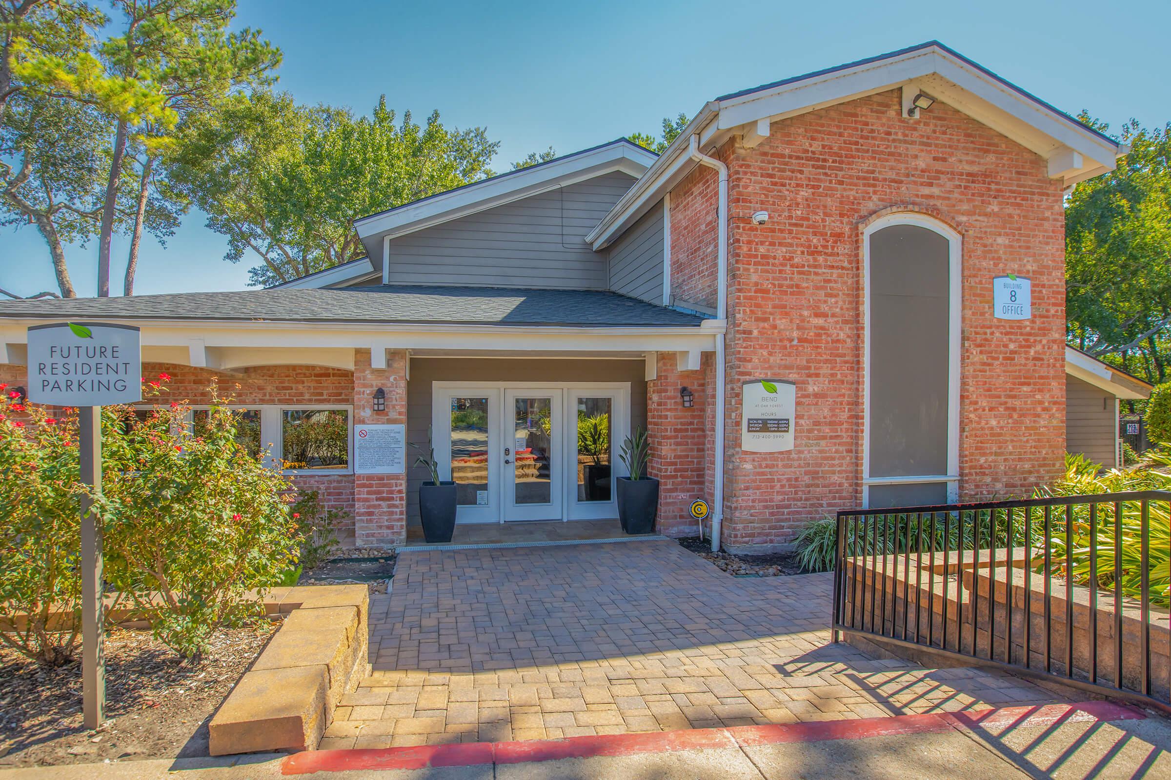 a bench in front of a brick building