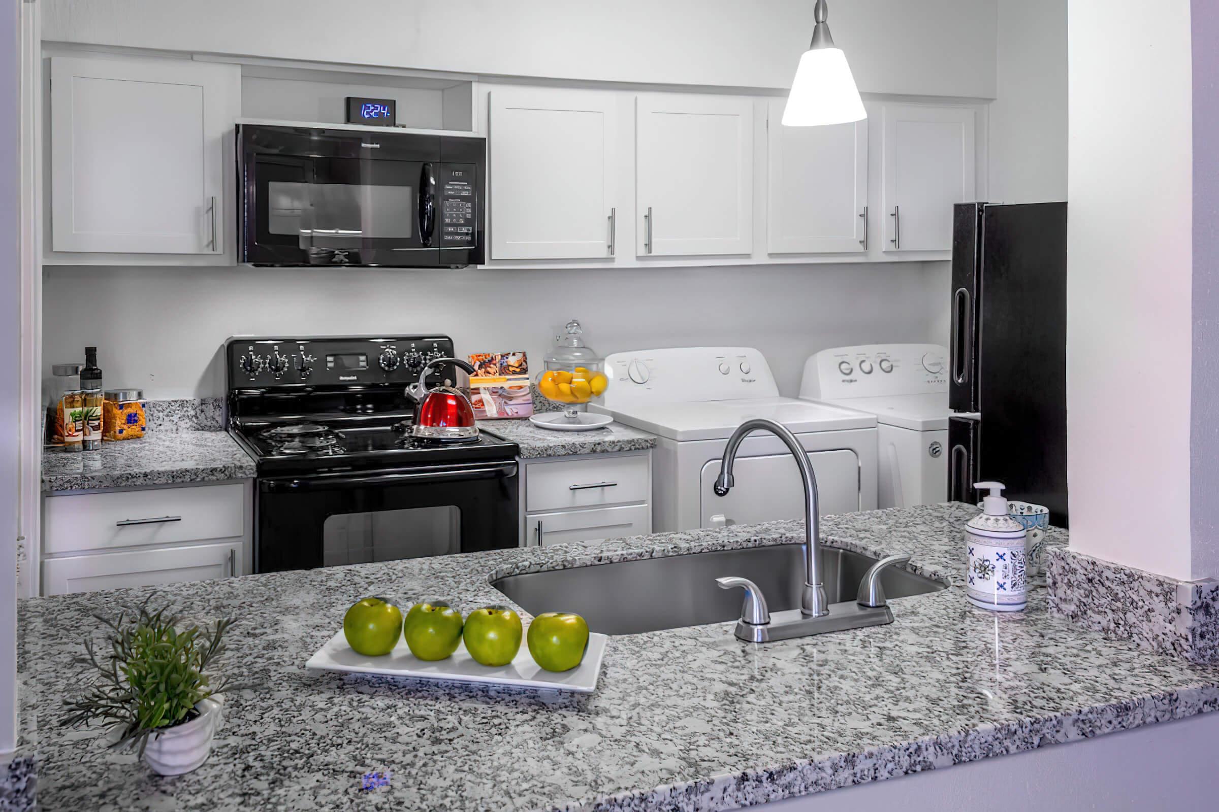 a kitchen with a sink and a microwave