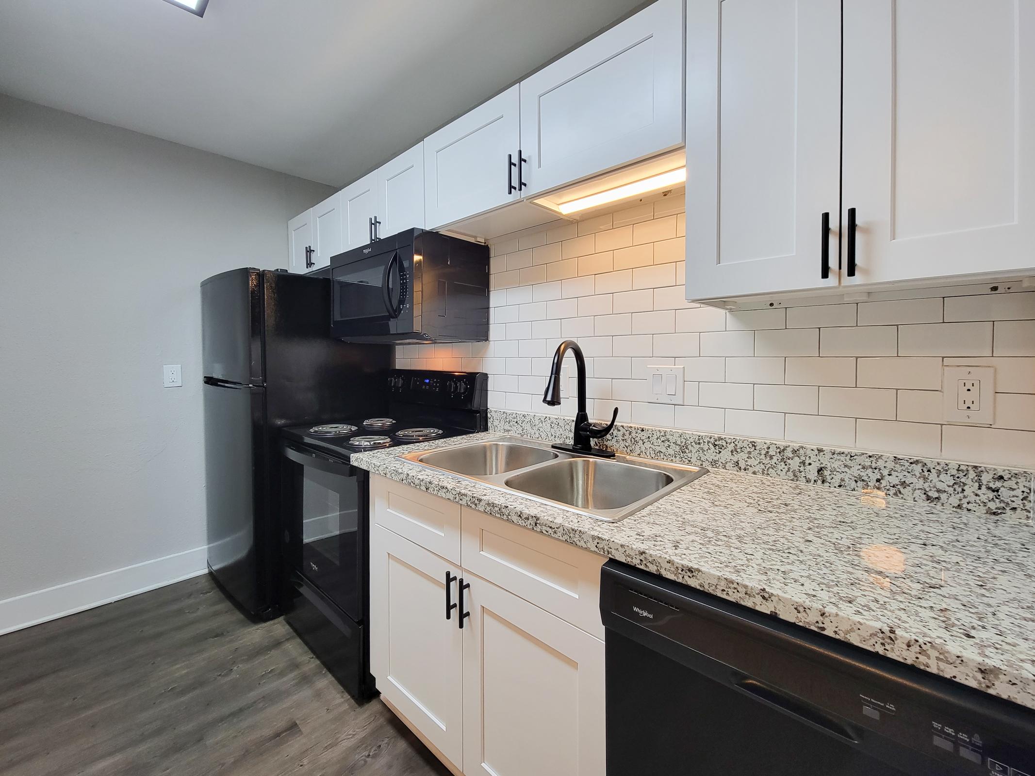 a kitchen with a stove and a sink