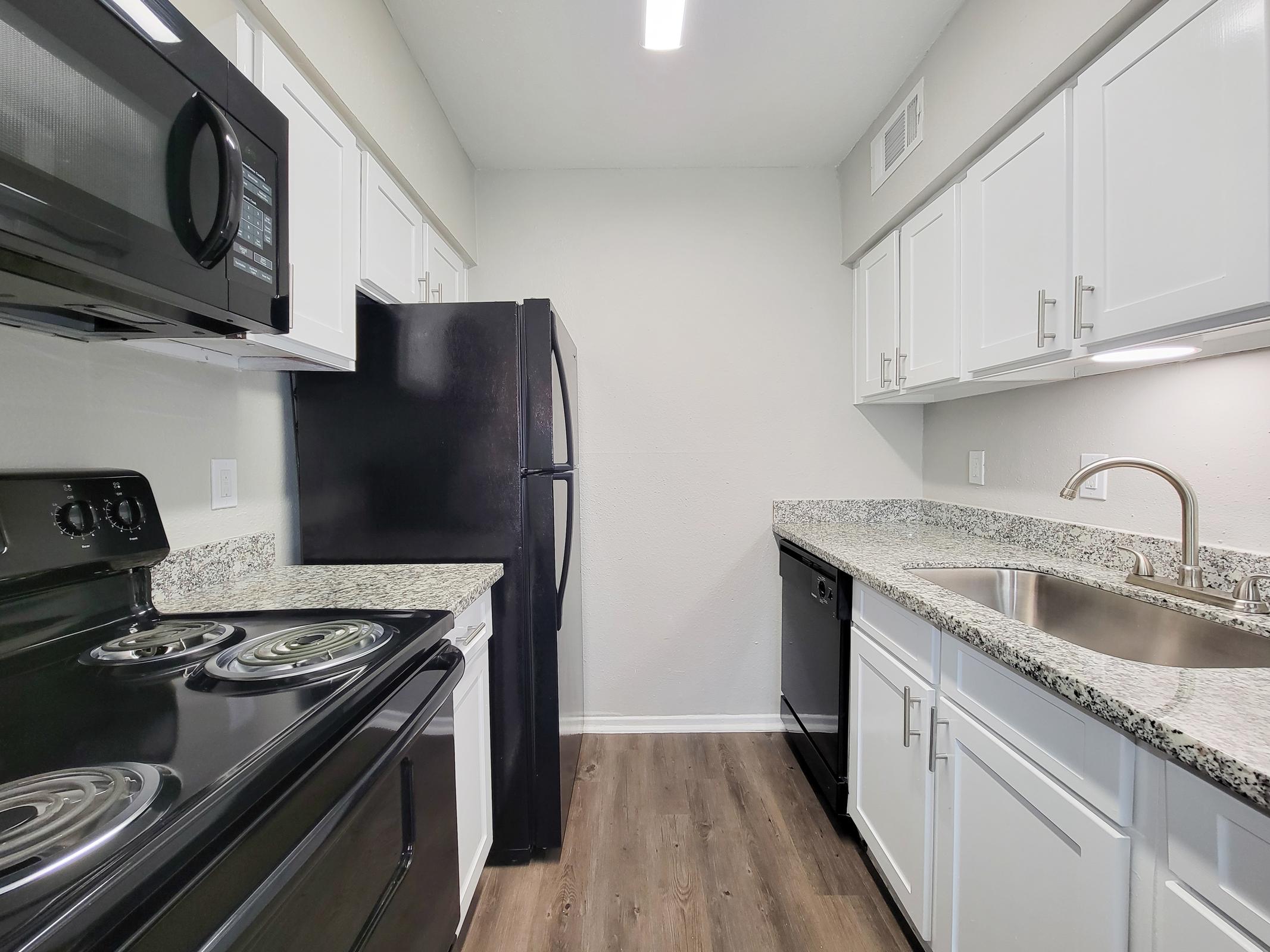 a kitchen with a stove and a sink