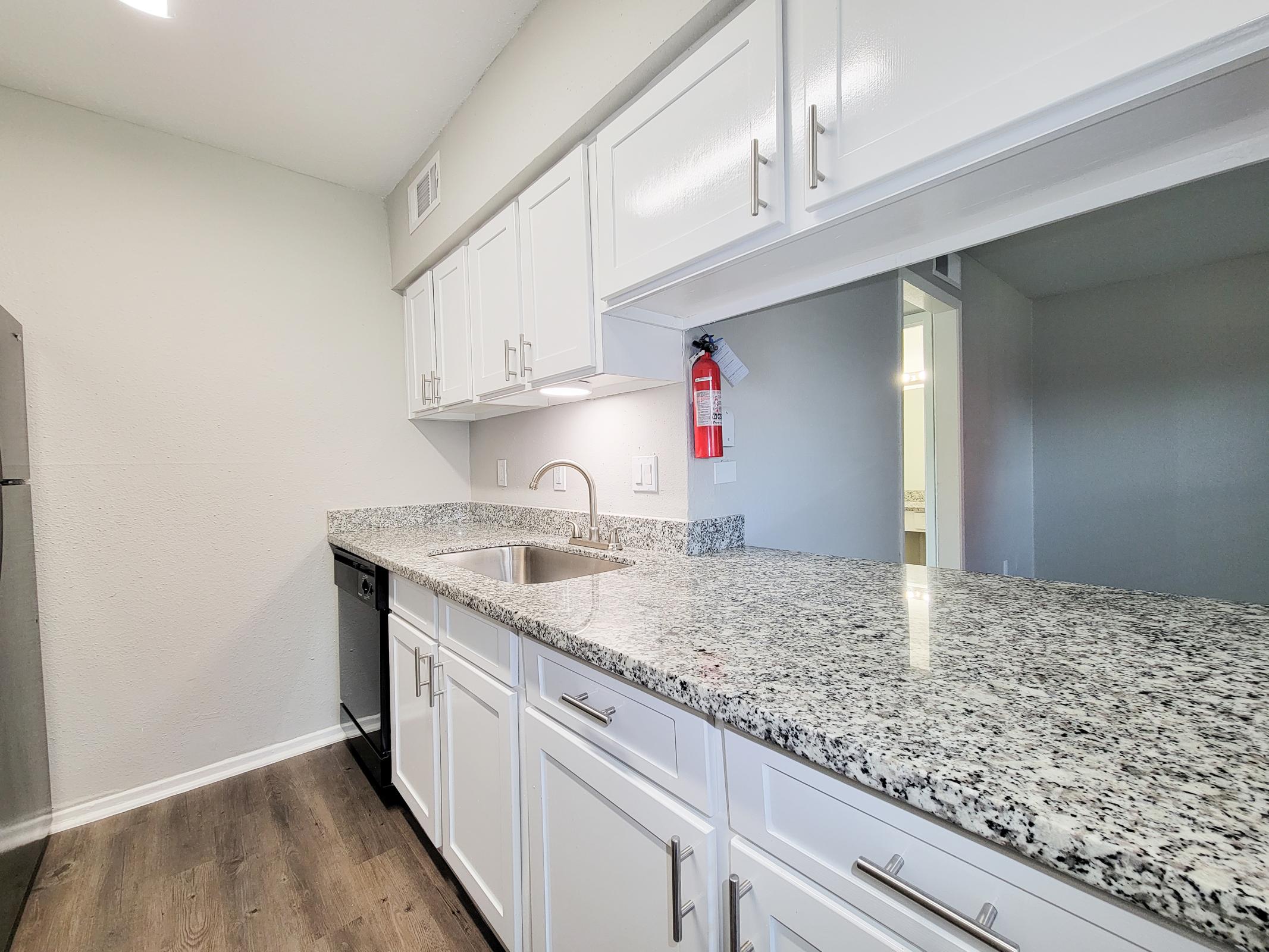 a kitchen with a sink and a mirror