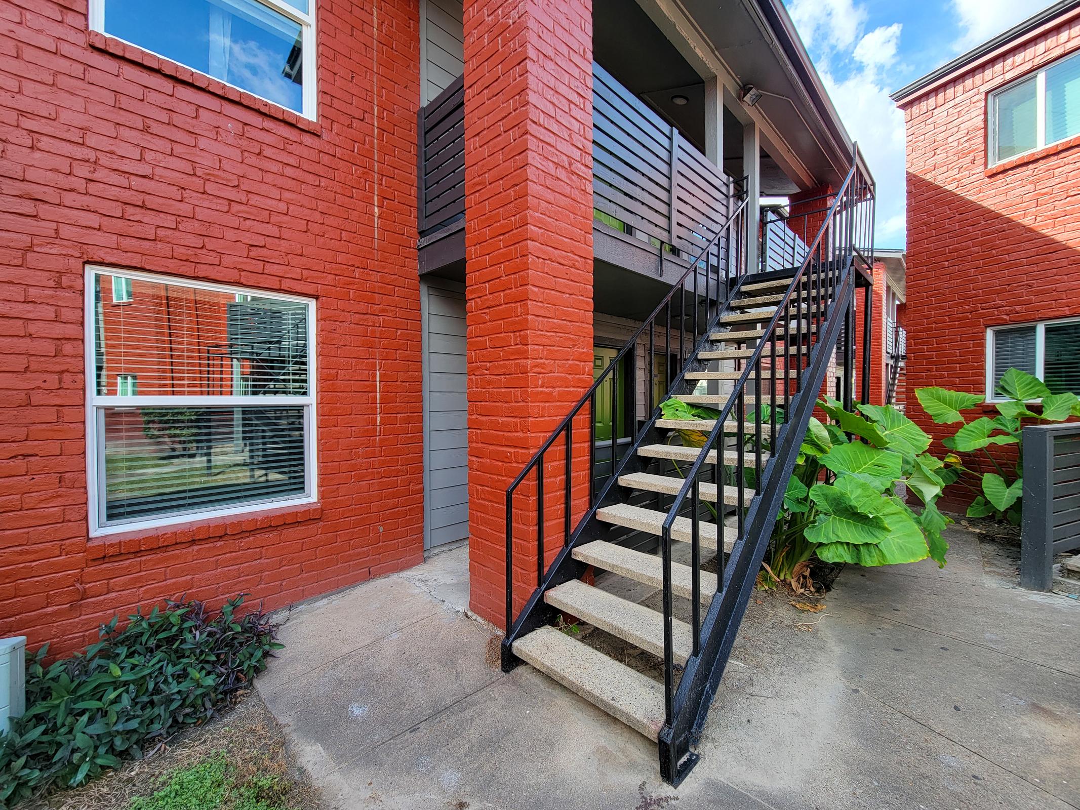 a bench in front of a brick building