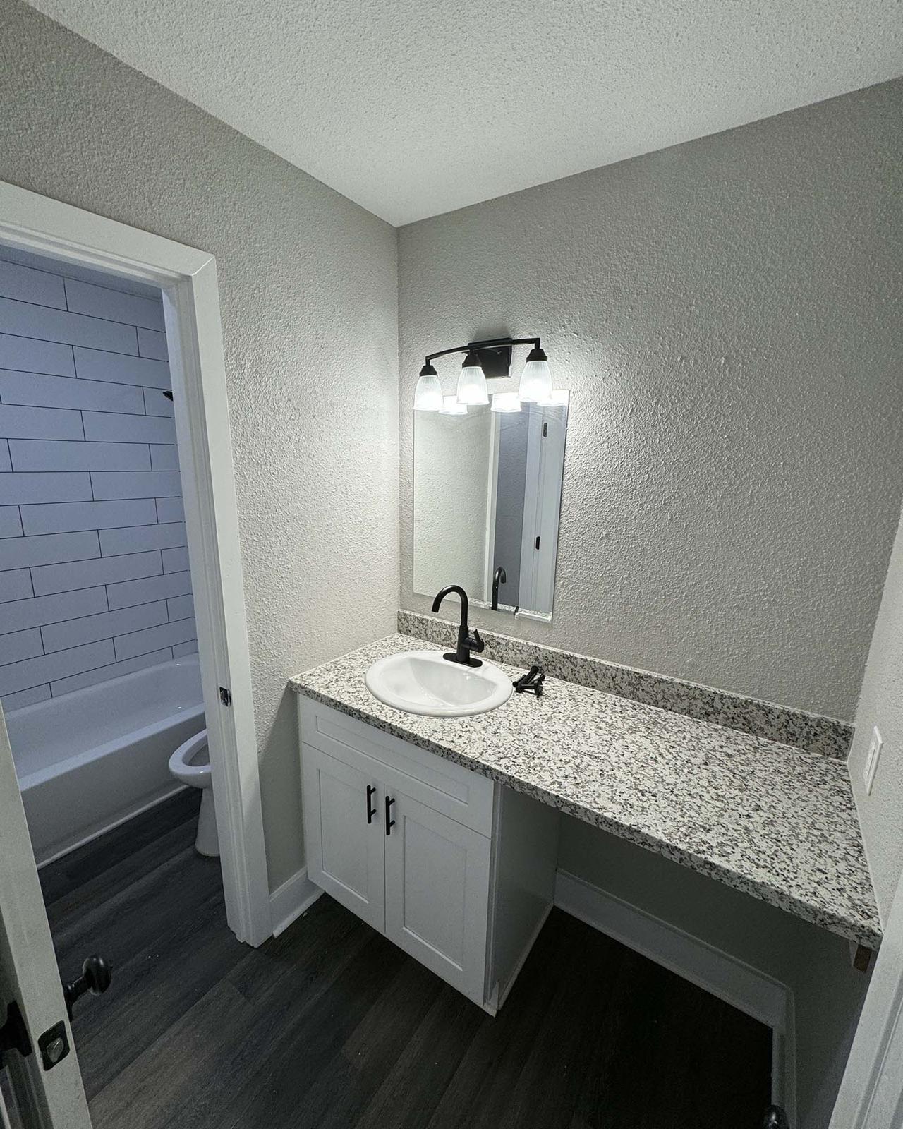 a room with a sink and a mirror