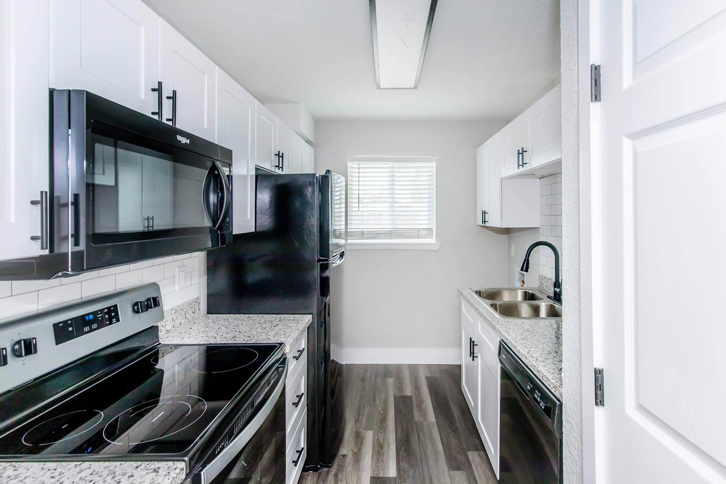 a stove top oven sitting inside of a kitchen