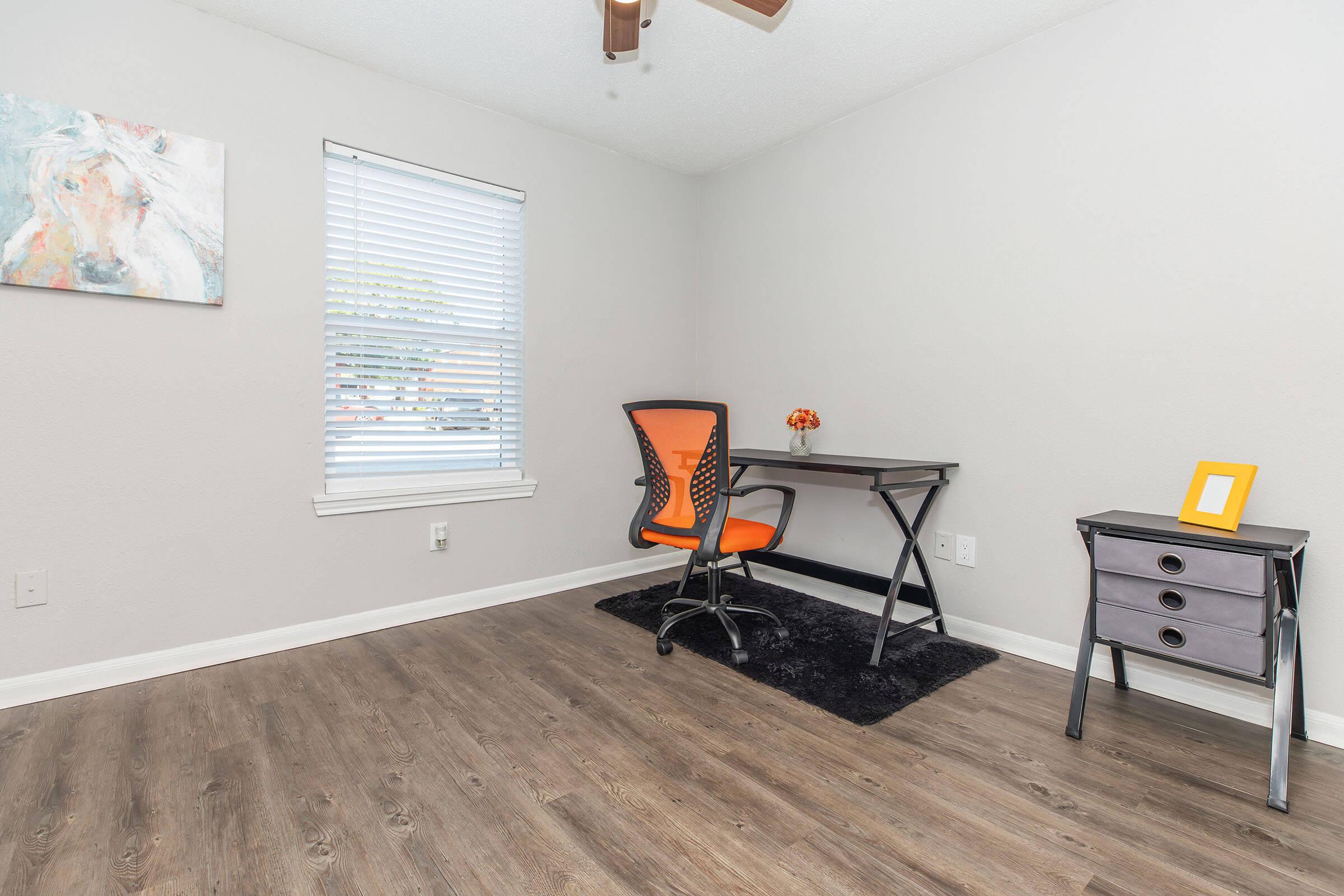 a bedroom with a bed and desk in a room