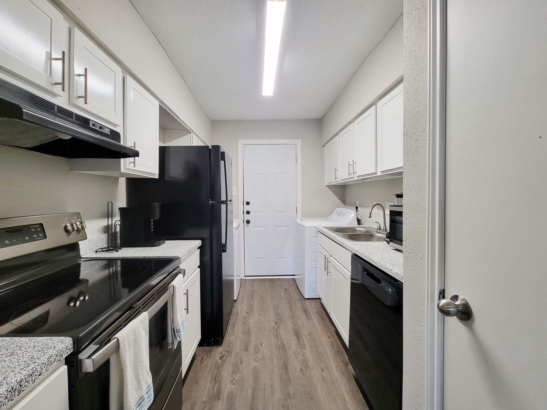 a kitchen with a stove and a sink