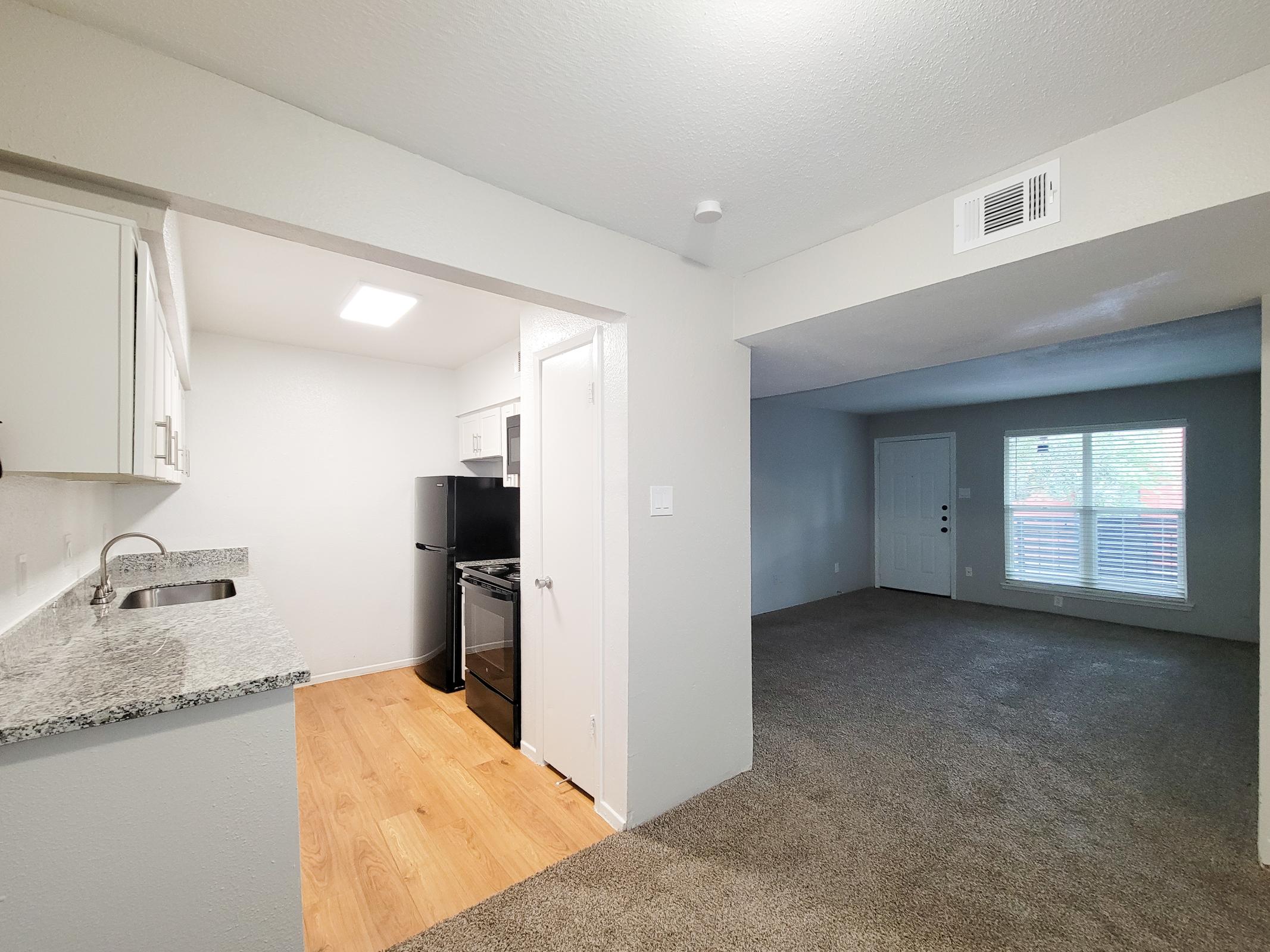 a kitchen area with a building in the background