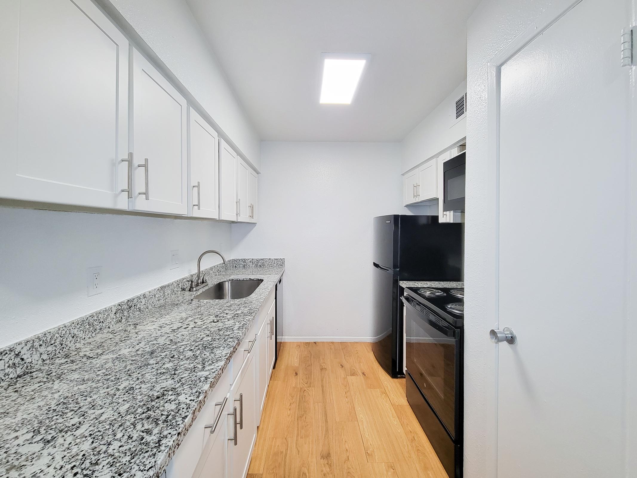 a kitchen with a sink and a mirror