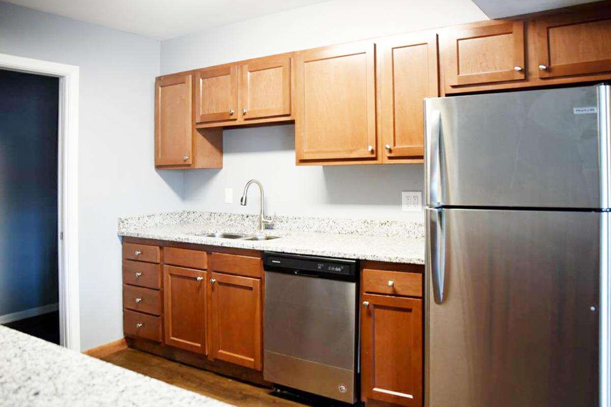 a kitchen with stainless steel appliances and wooden cabinets