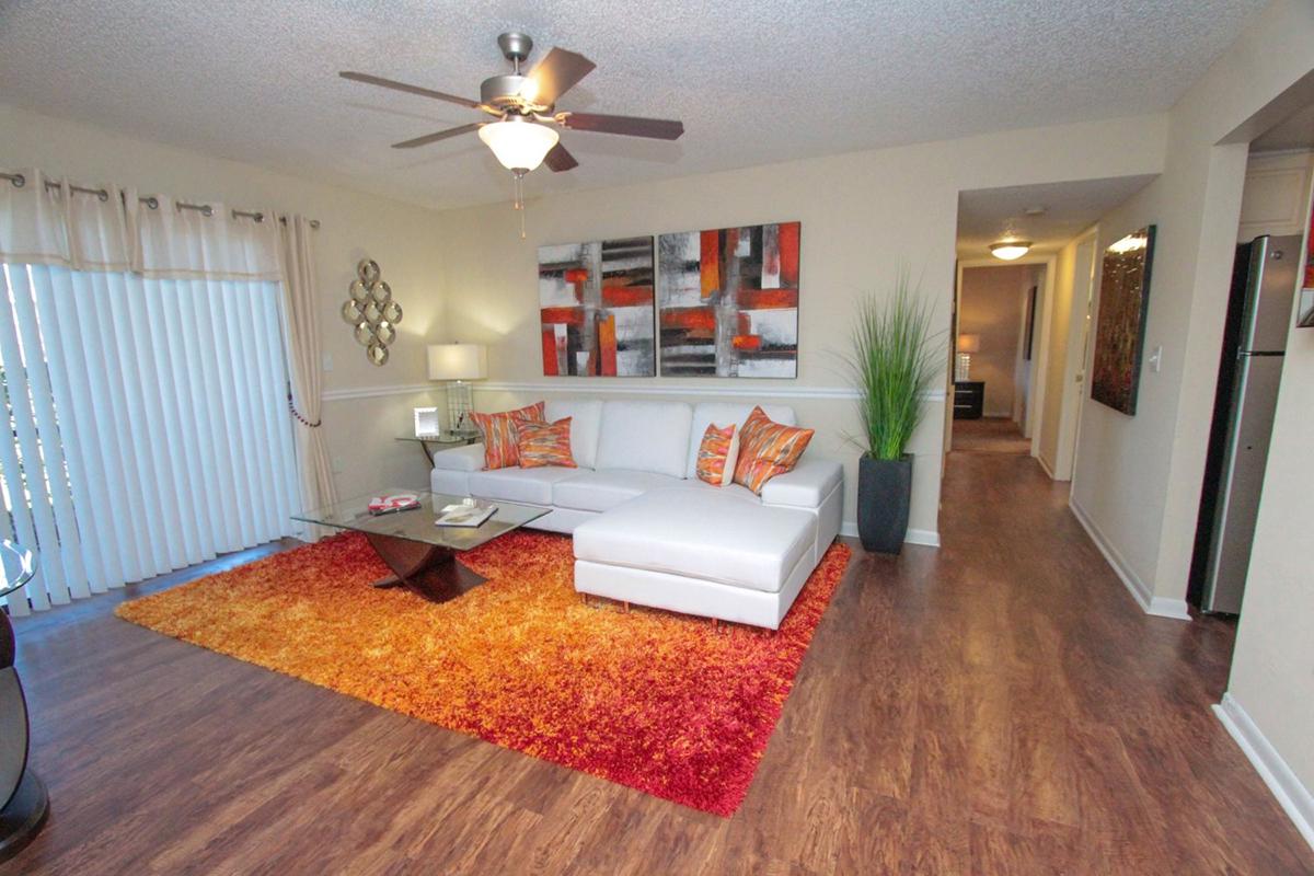 a living room filled with furniture and a flat screen tv