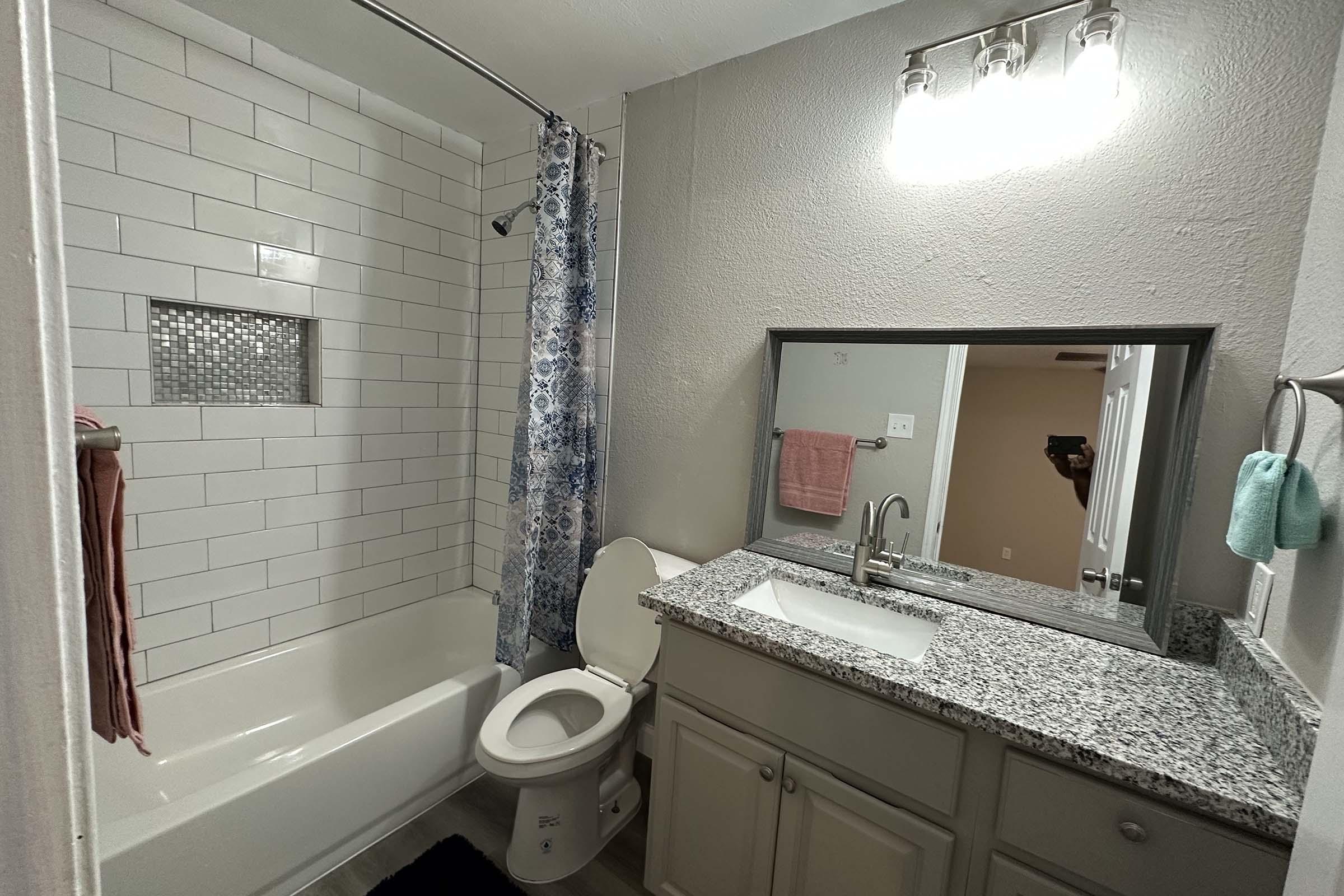 a room with a sink and a mirror