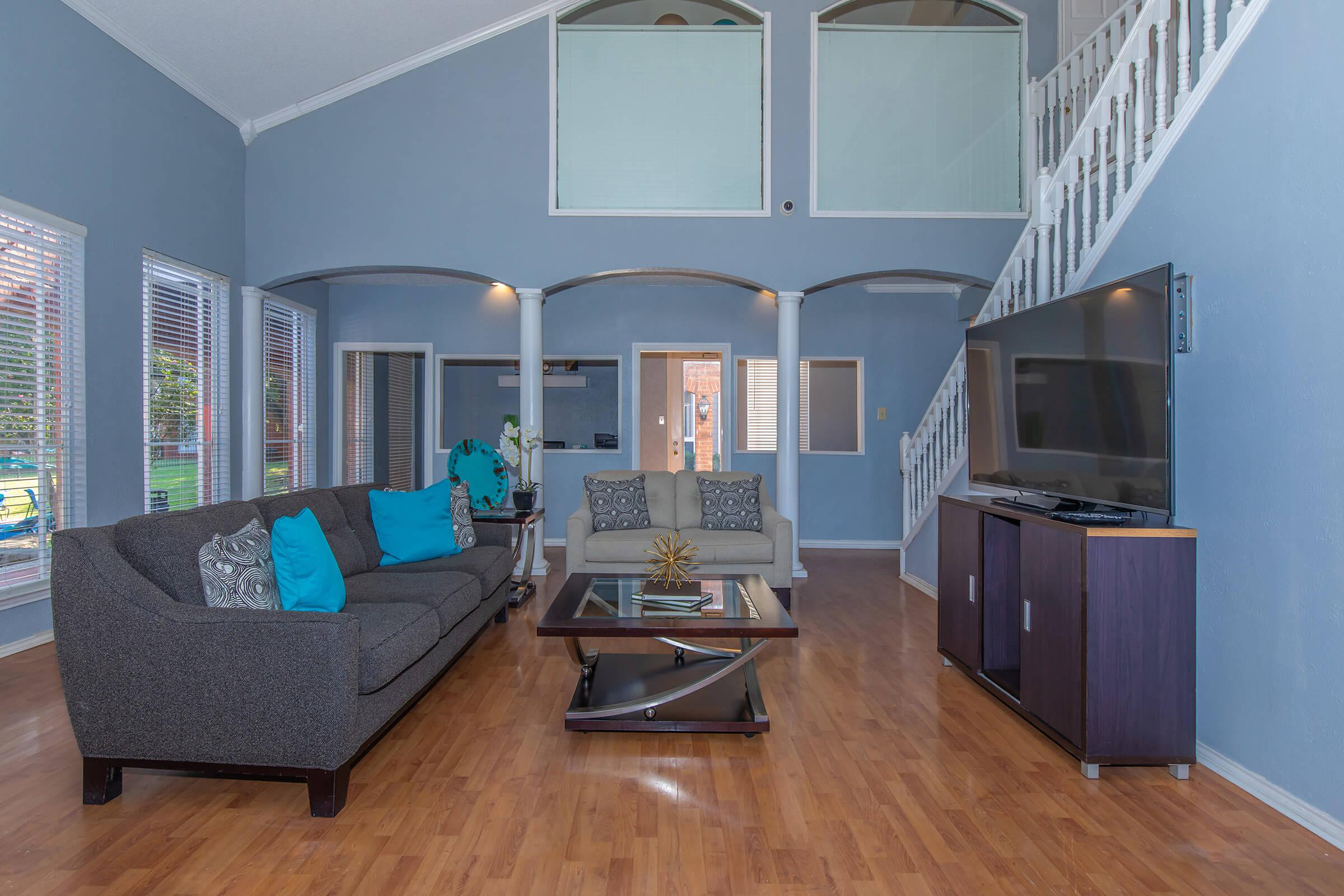 a living room filled with furniture and a large window