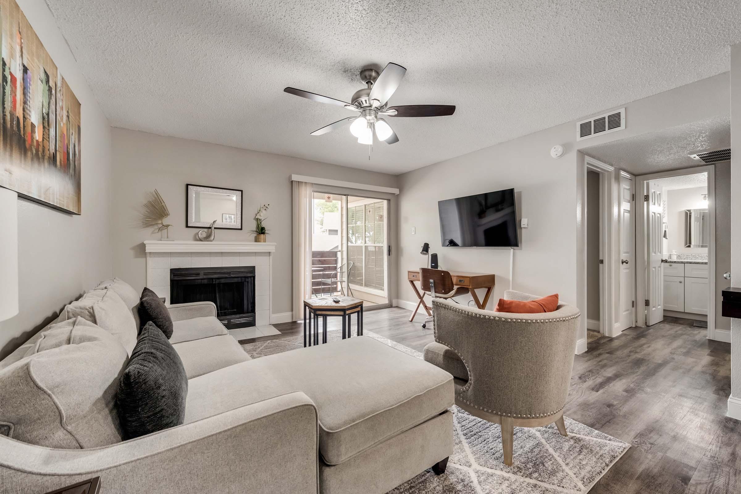 a living room filled with furniture and a large window