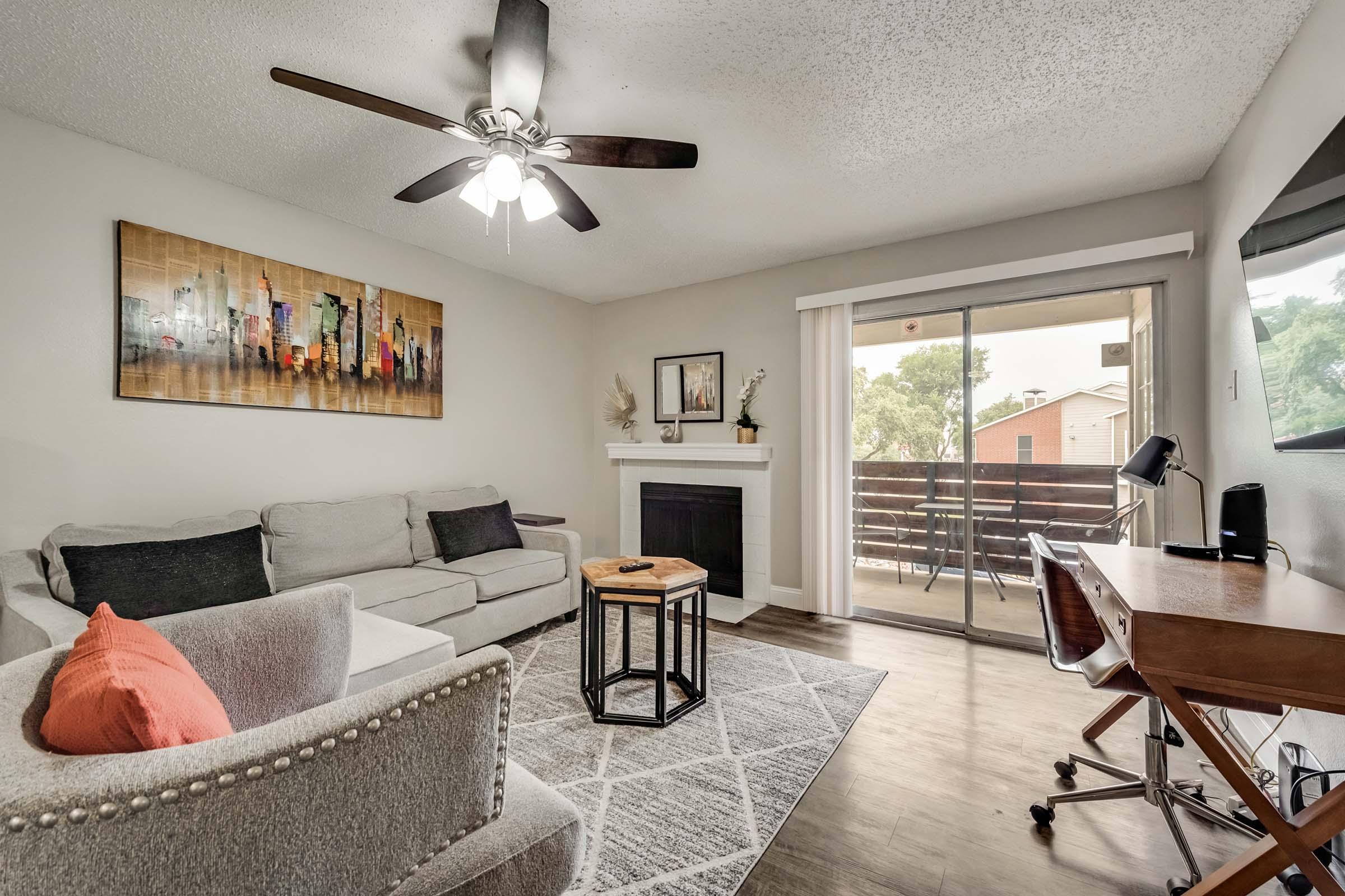 a living room filled with furniture and a large window