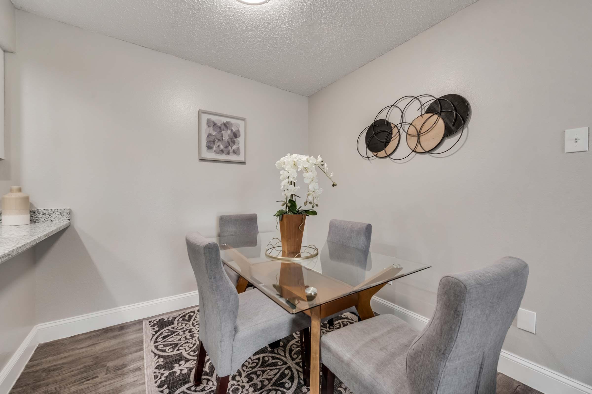 a living room filled with furniture and vase on a table