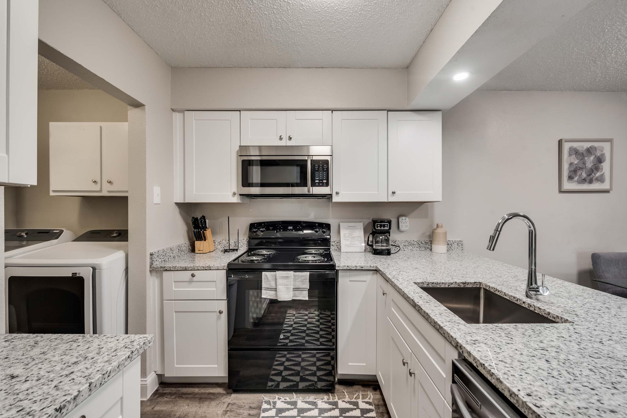 a kitchen with a sink and a microwave