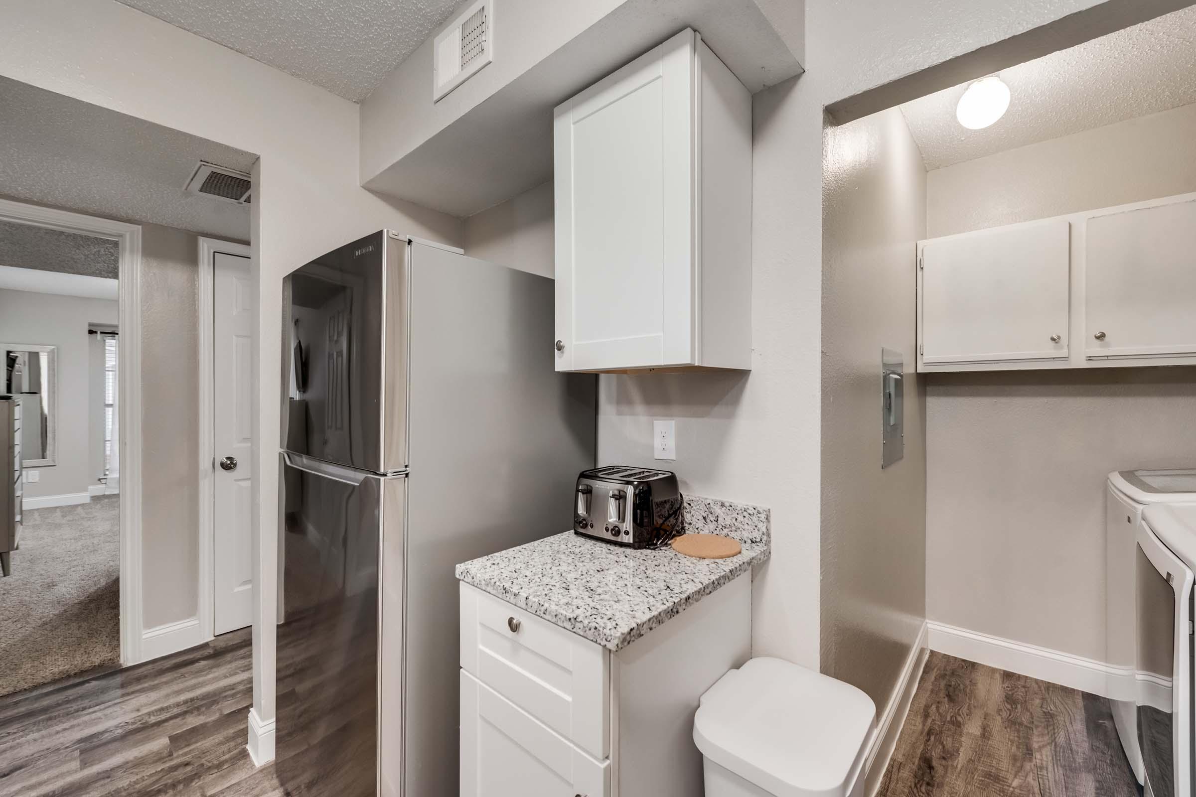 a kitchen with a sink and a mirror