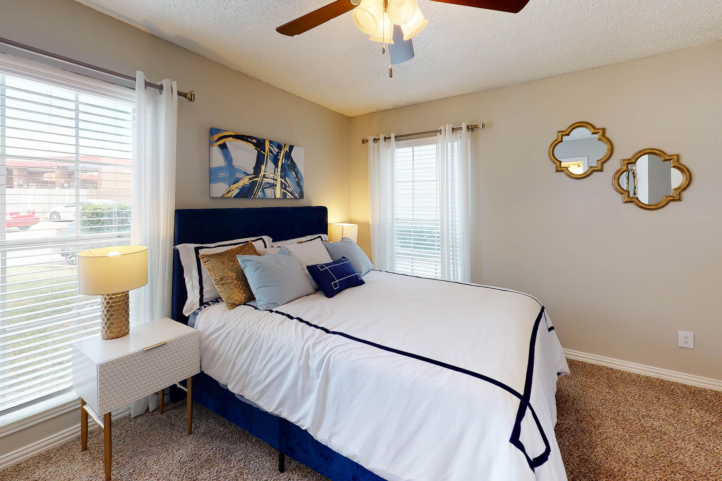 a bedroom with a bed and desk in a room