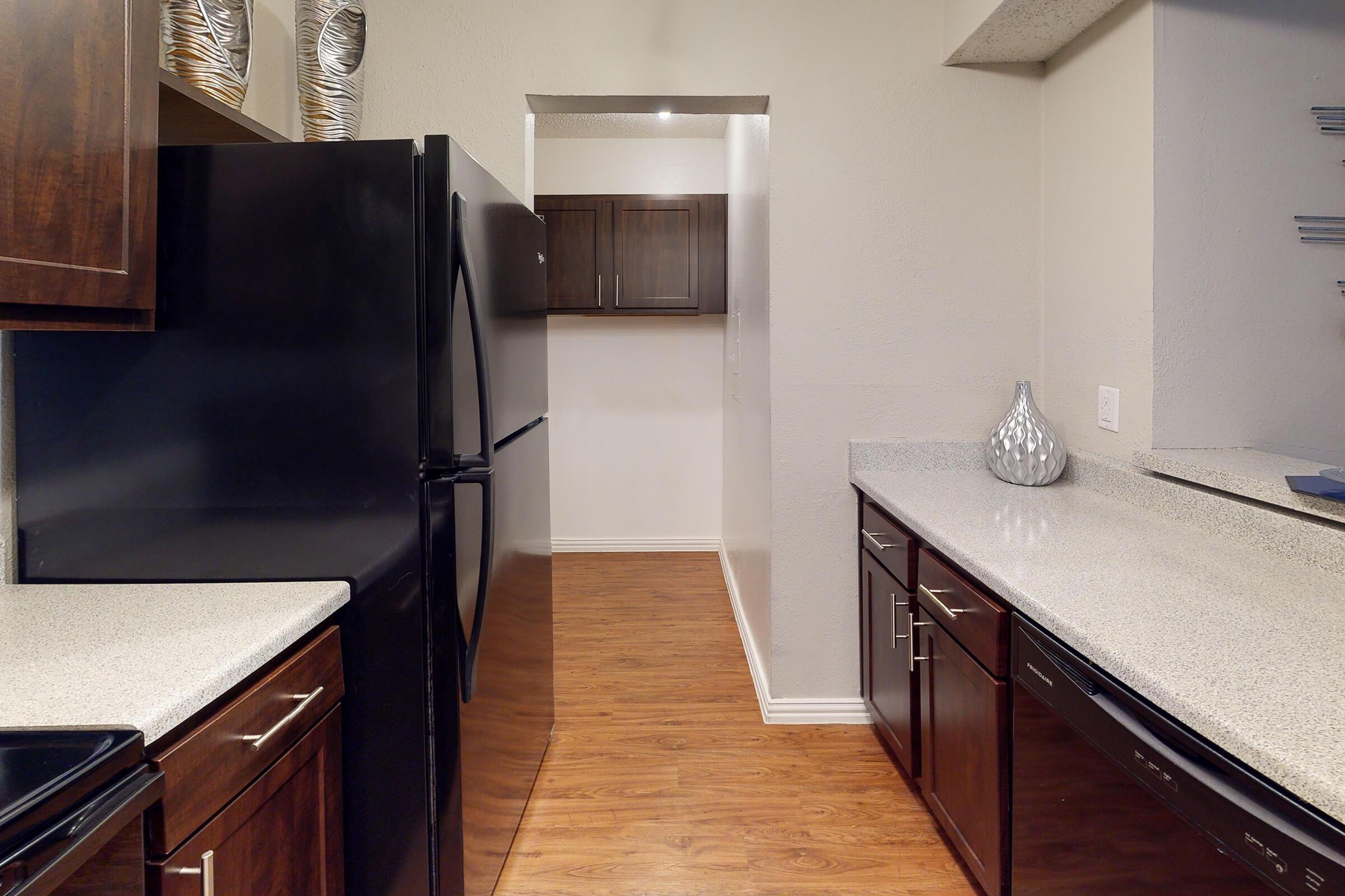 a kitchen with stainless steel appliances and wooden cabinets