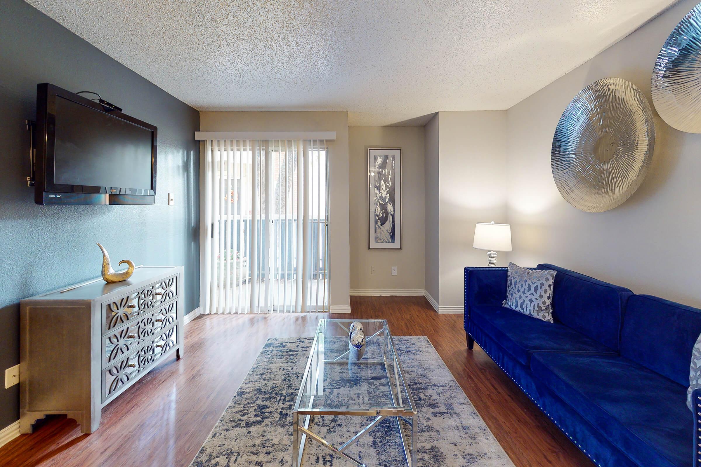 a living room filled with furniture and a large window