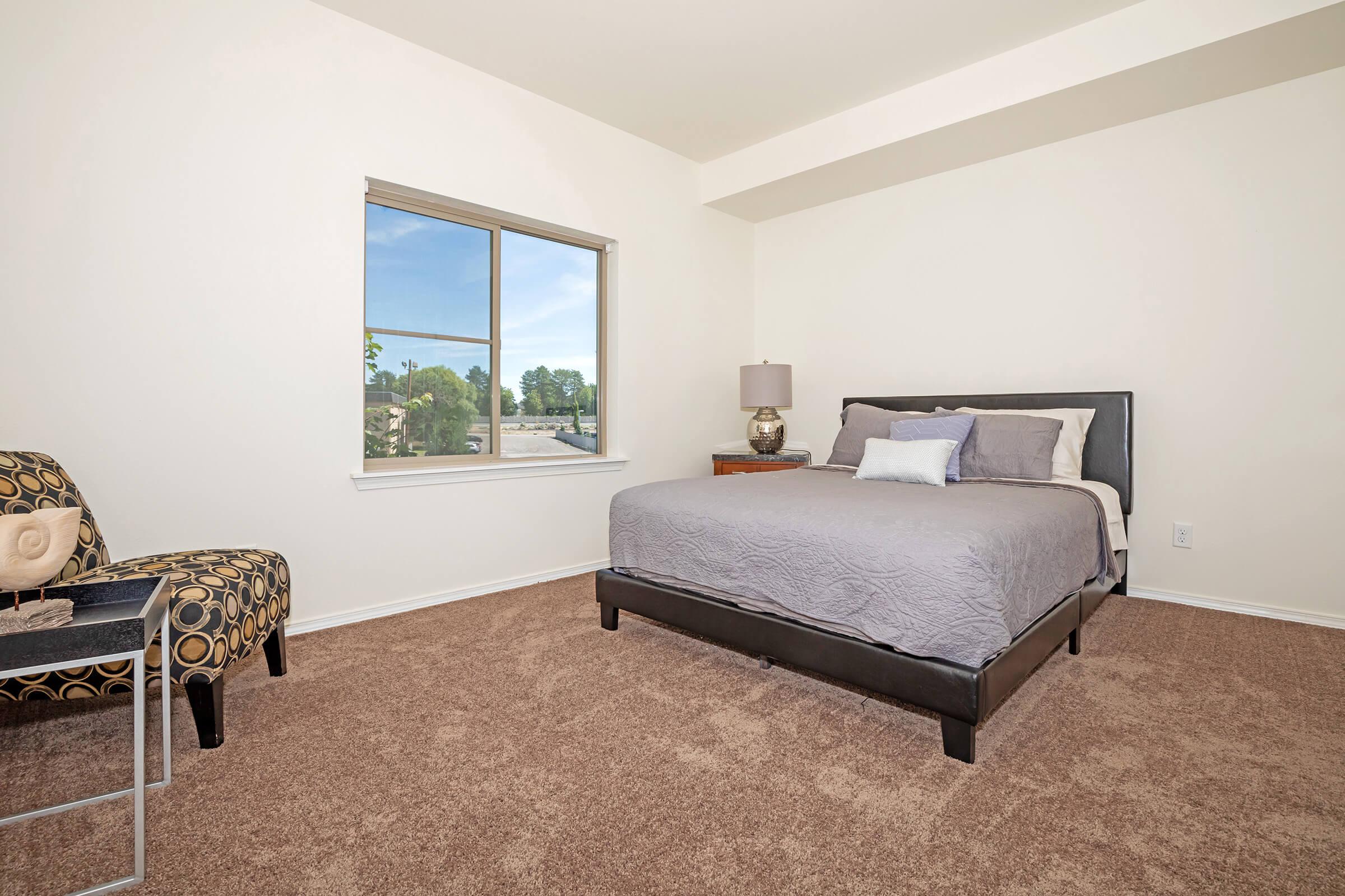 a bedroom with a bed in a room