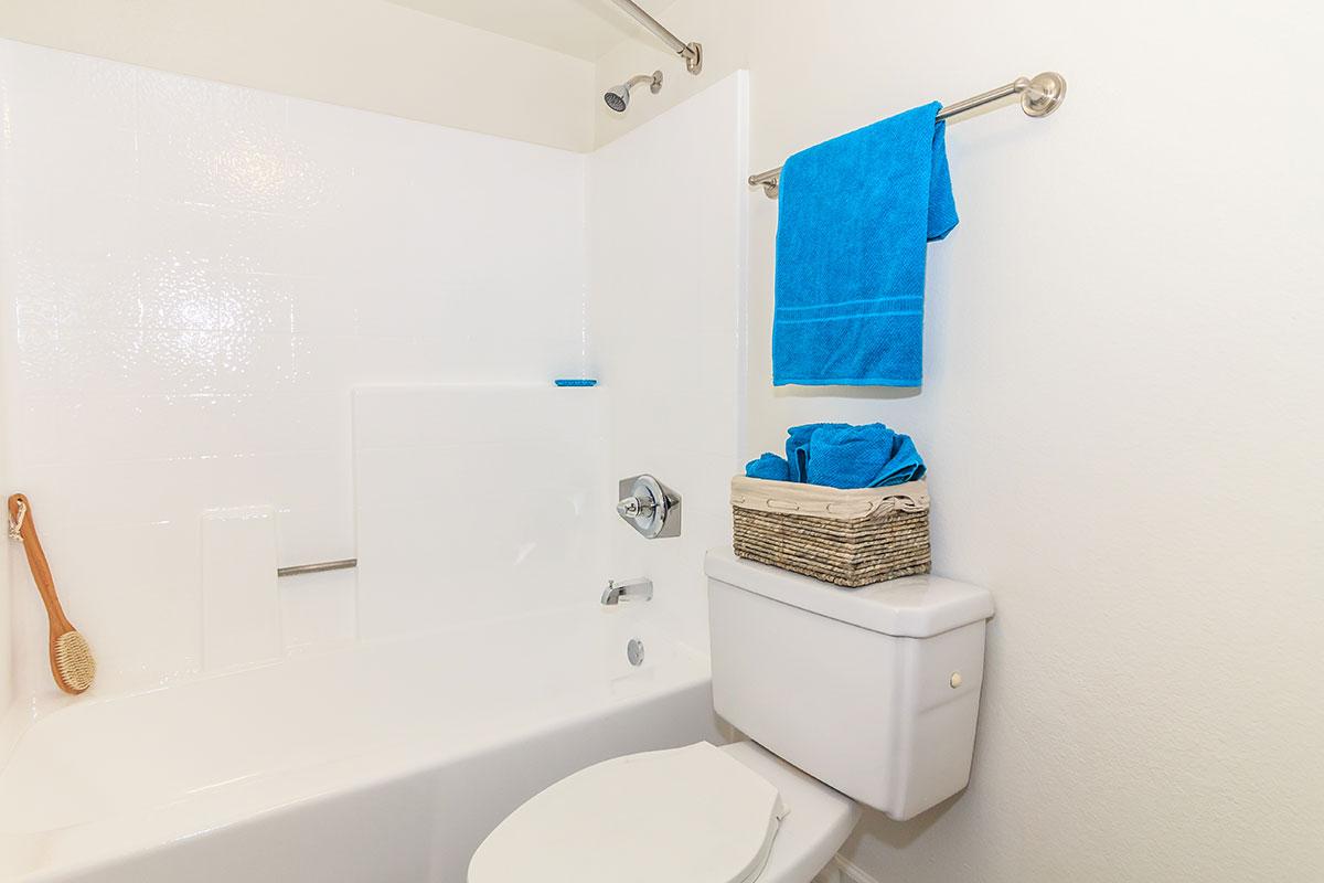 a white tub sitting next to a sink