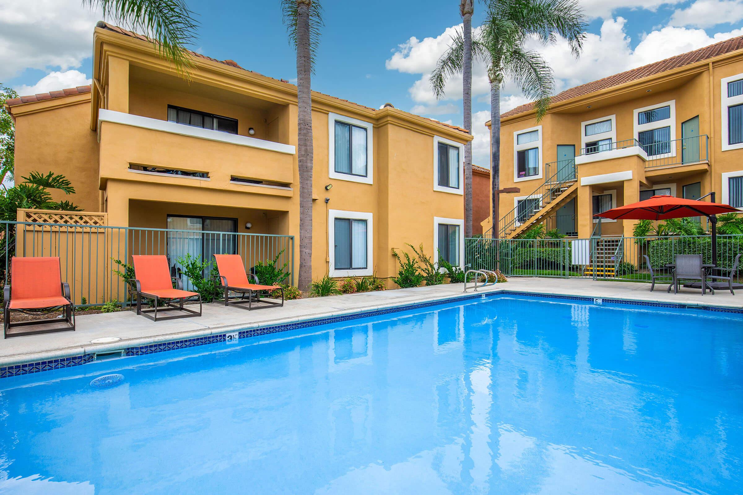 a house with a pool in front of a building