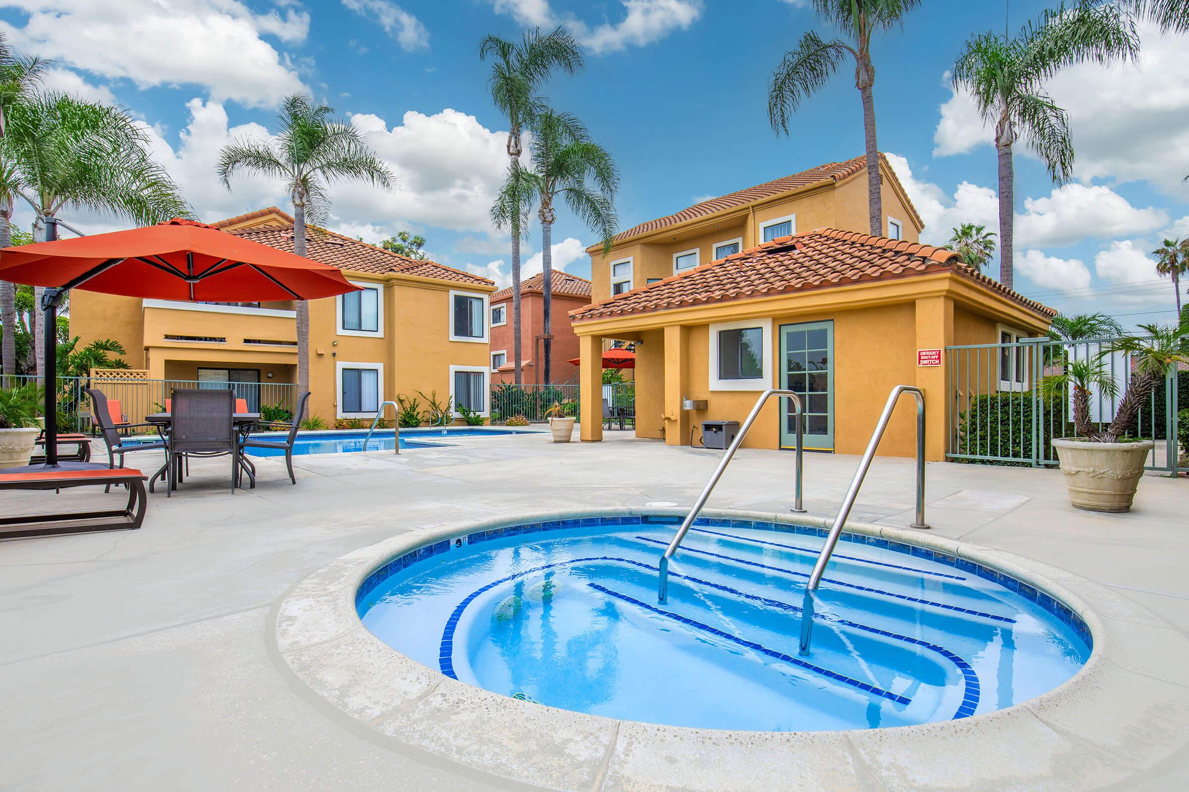 a house with a pool in front of a building