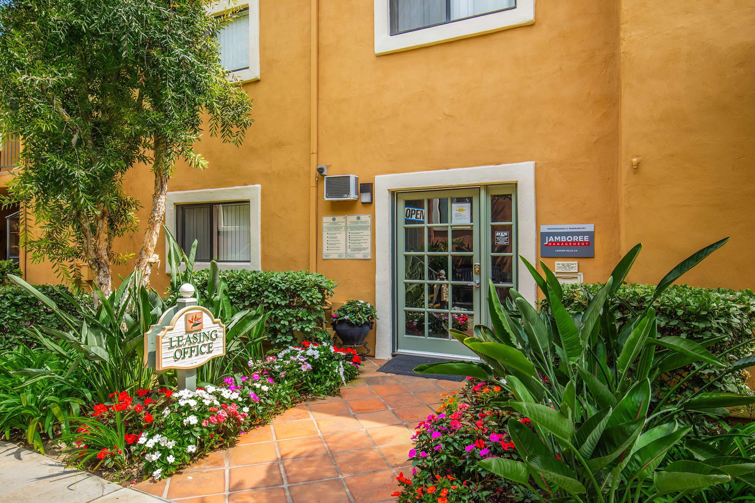 a close up of a flower garden in front of a building