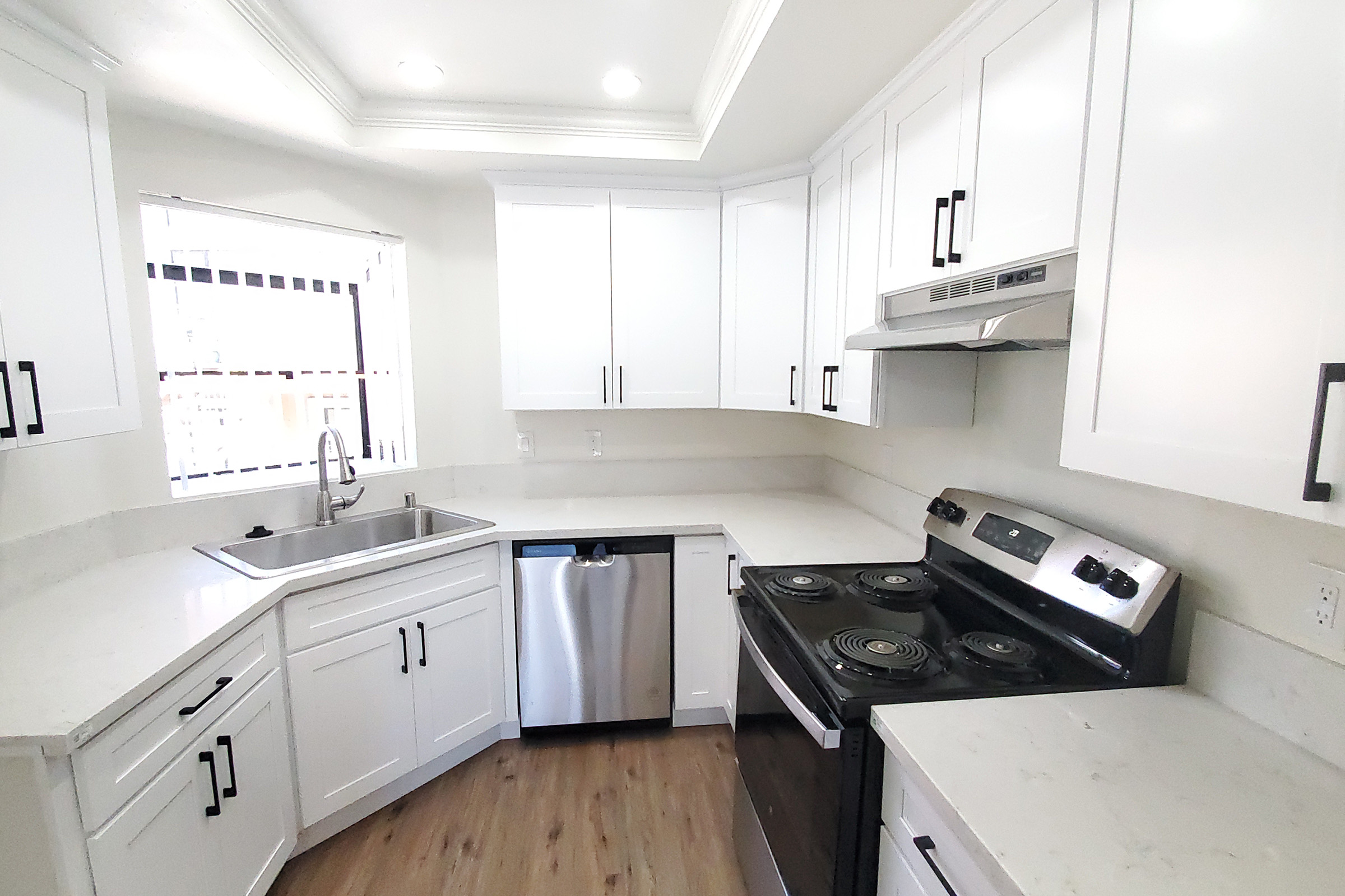 a stove top oven sitting inside of a kitchen