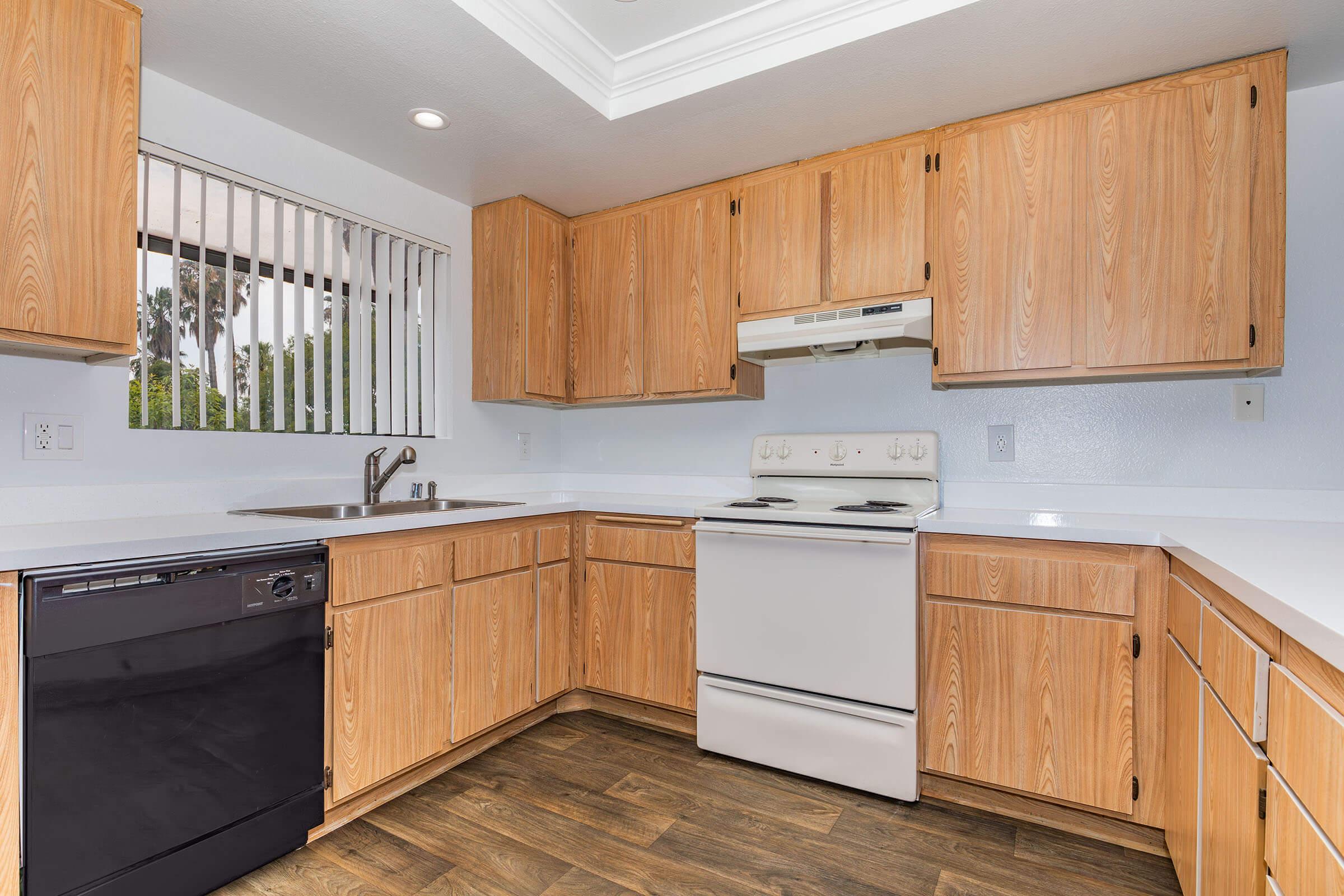 a kitchen with wooden cabinets and a refrigerator