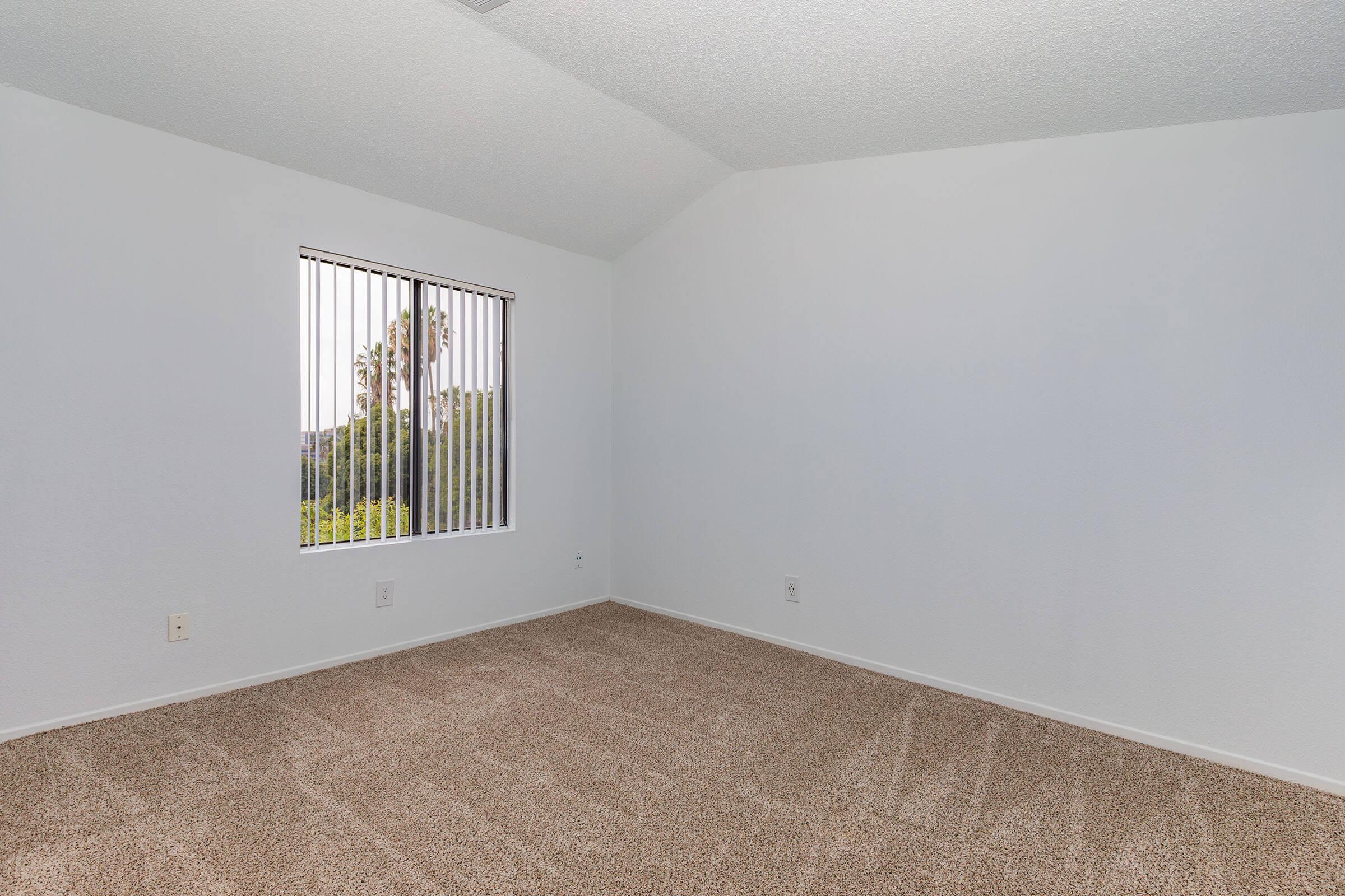 a bedroom with a bed in a small room