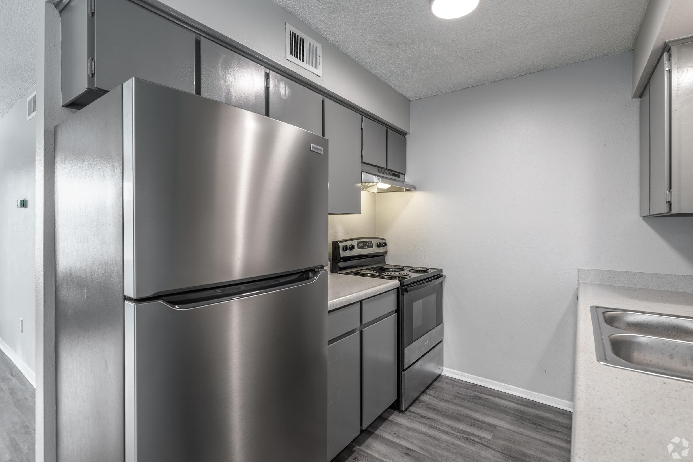 Kitchen has stainless steel appliances at Windsor Gardens apartments in Yukon Oklahoma