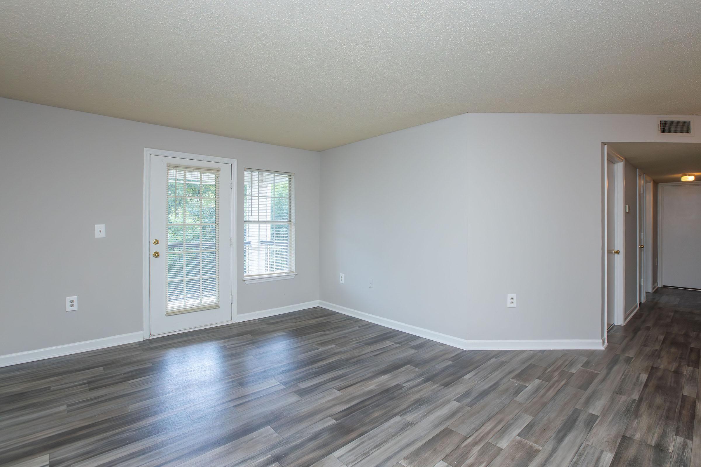 a large empty room with a wooden floor