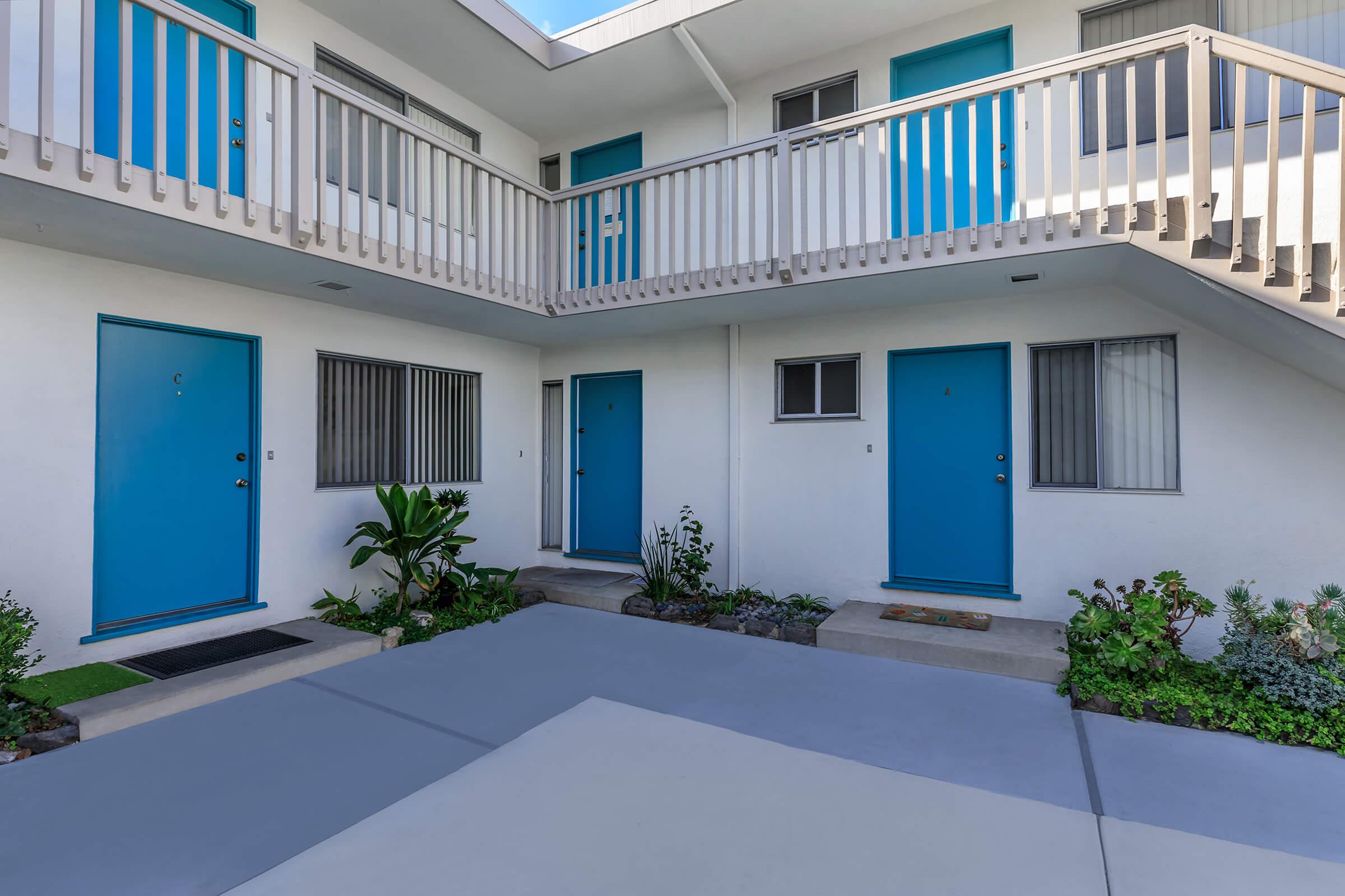 Sea Breeze Beach Apartments community building with blue doors