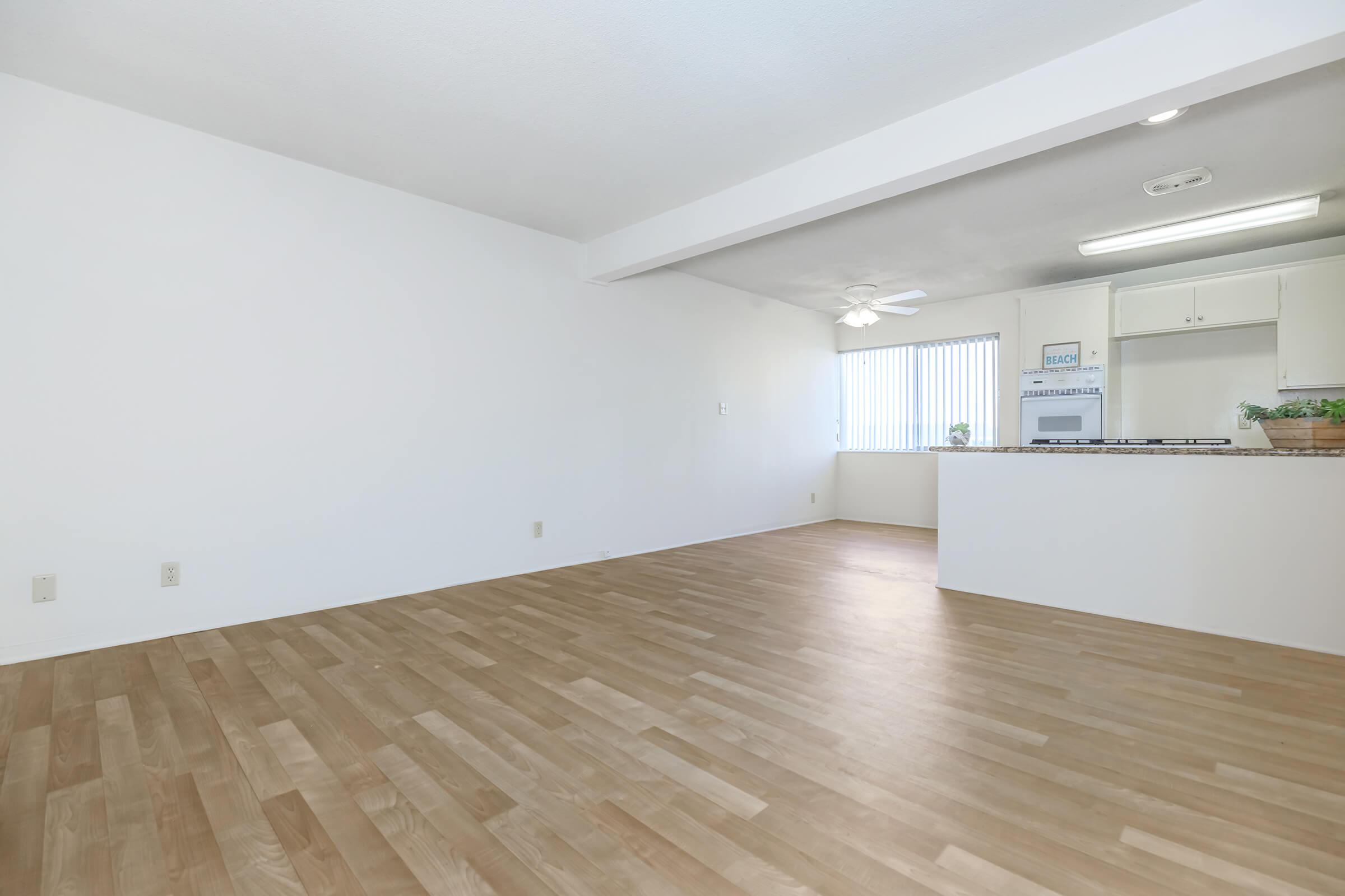 Unfurnished living room with wooden floors