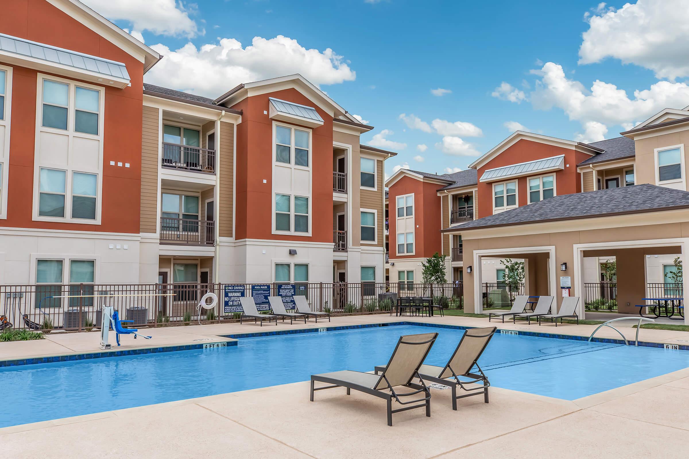 a house with a pool in front of a building