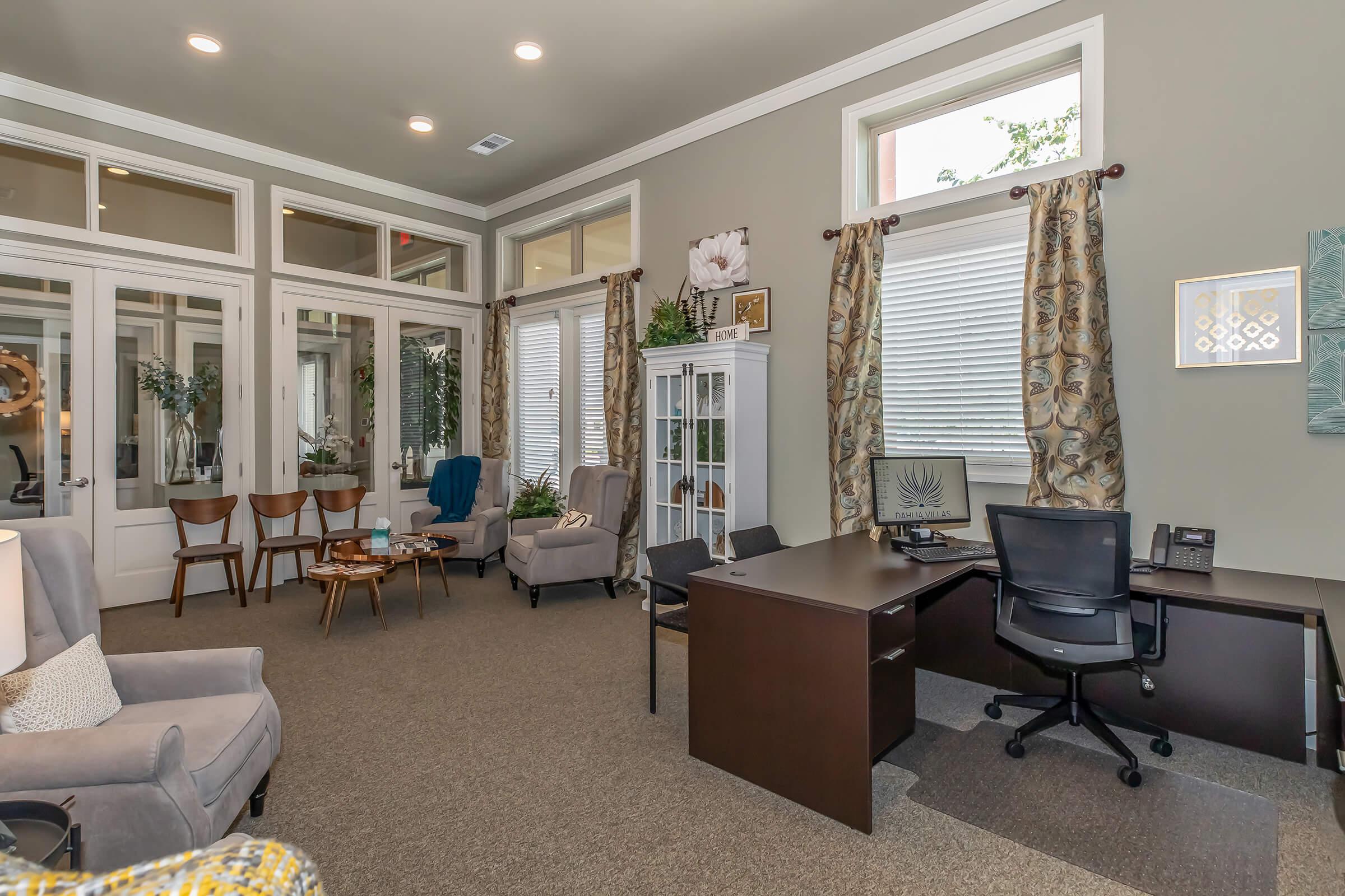 a living room filled with furniture and a large window