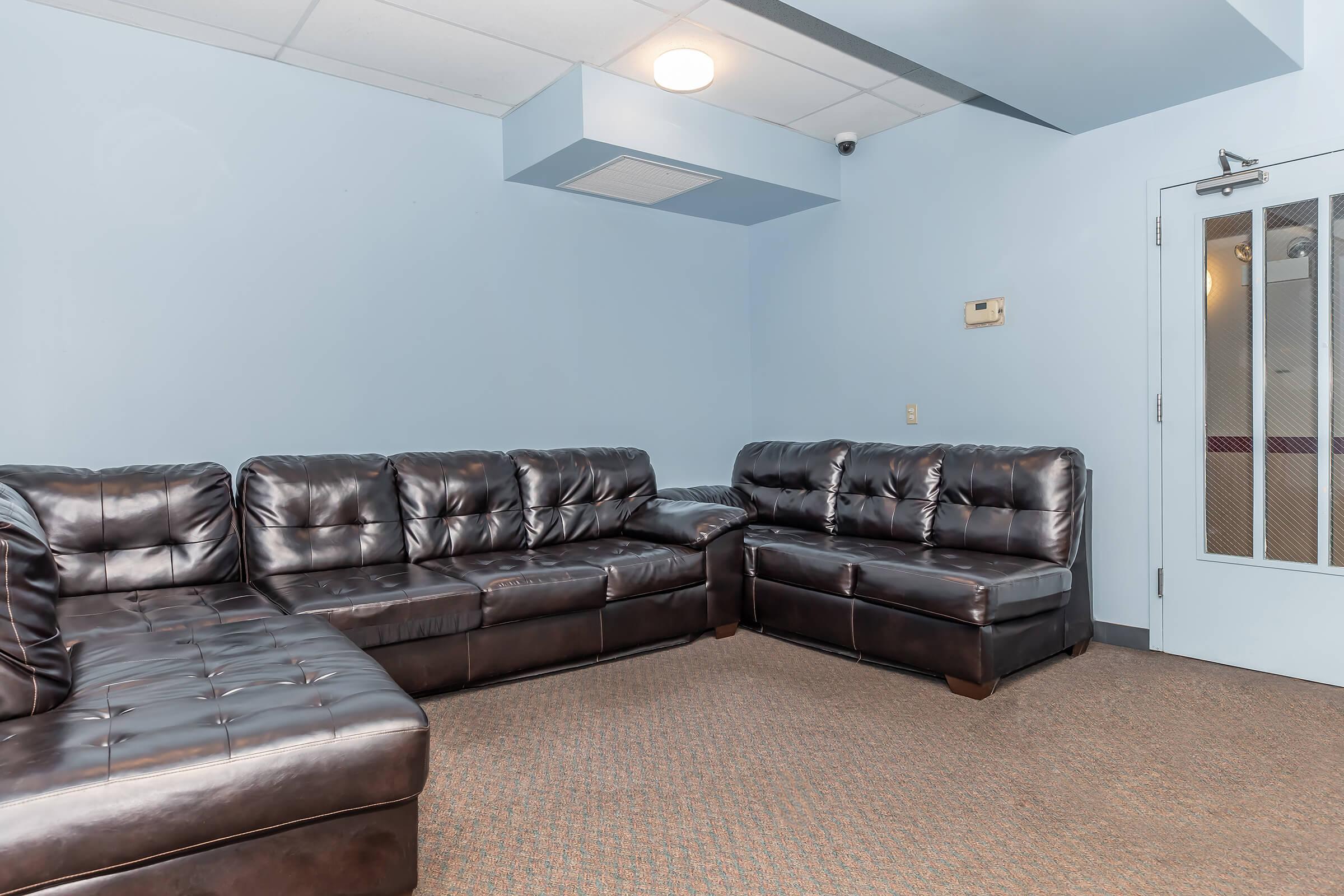 a brown leather couch in a living room