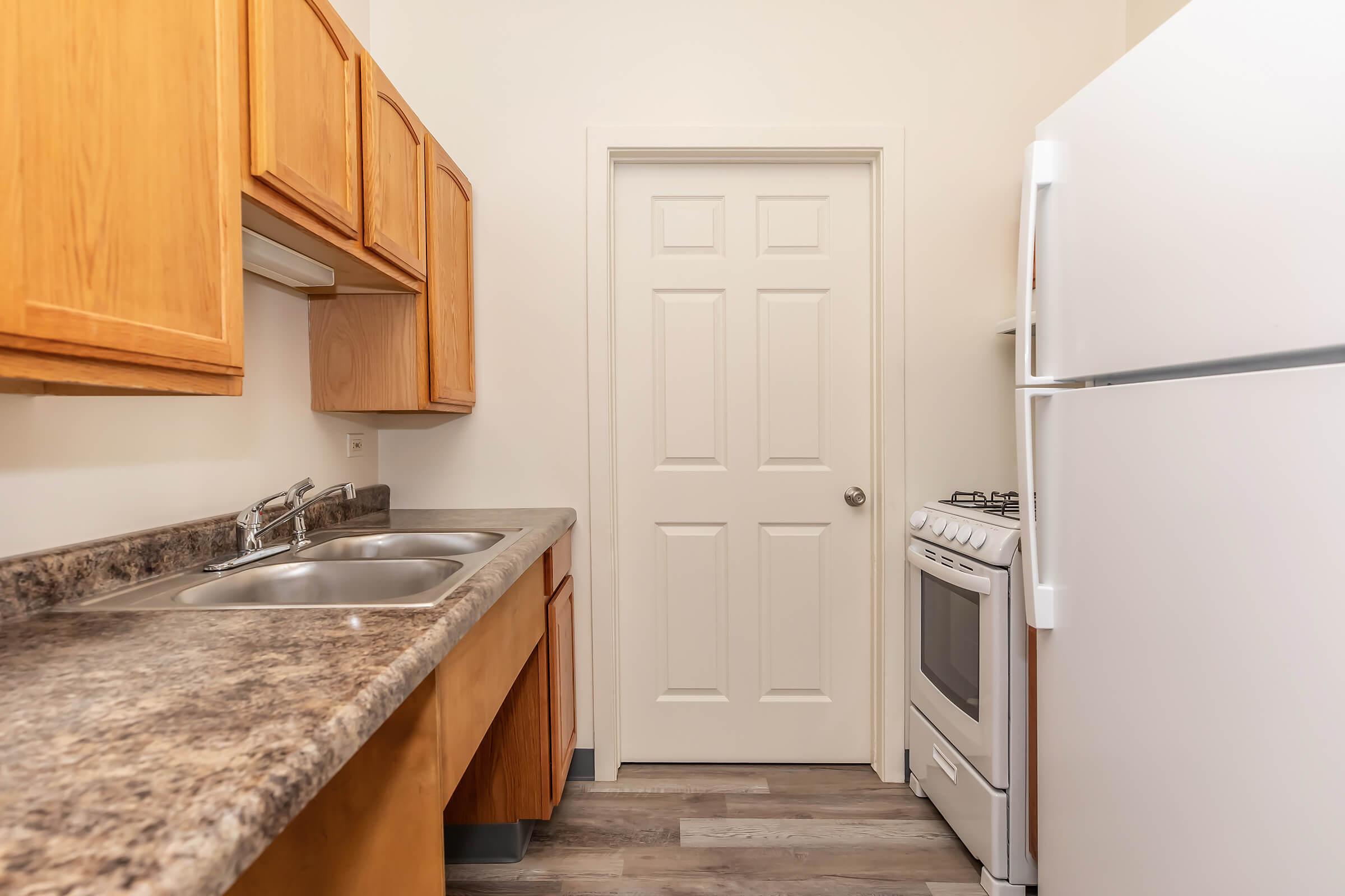 a kitchen with a sink and a refrigerator