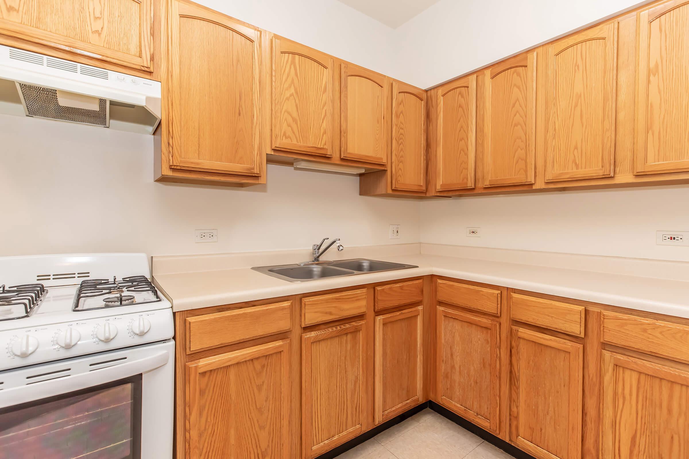 a kitchen with wooden cabinets and a microwave