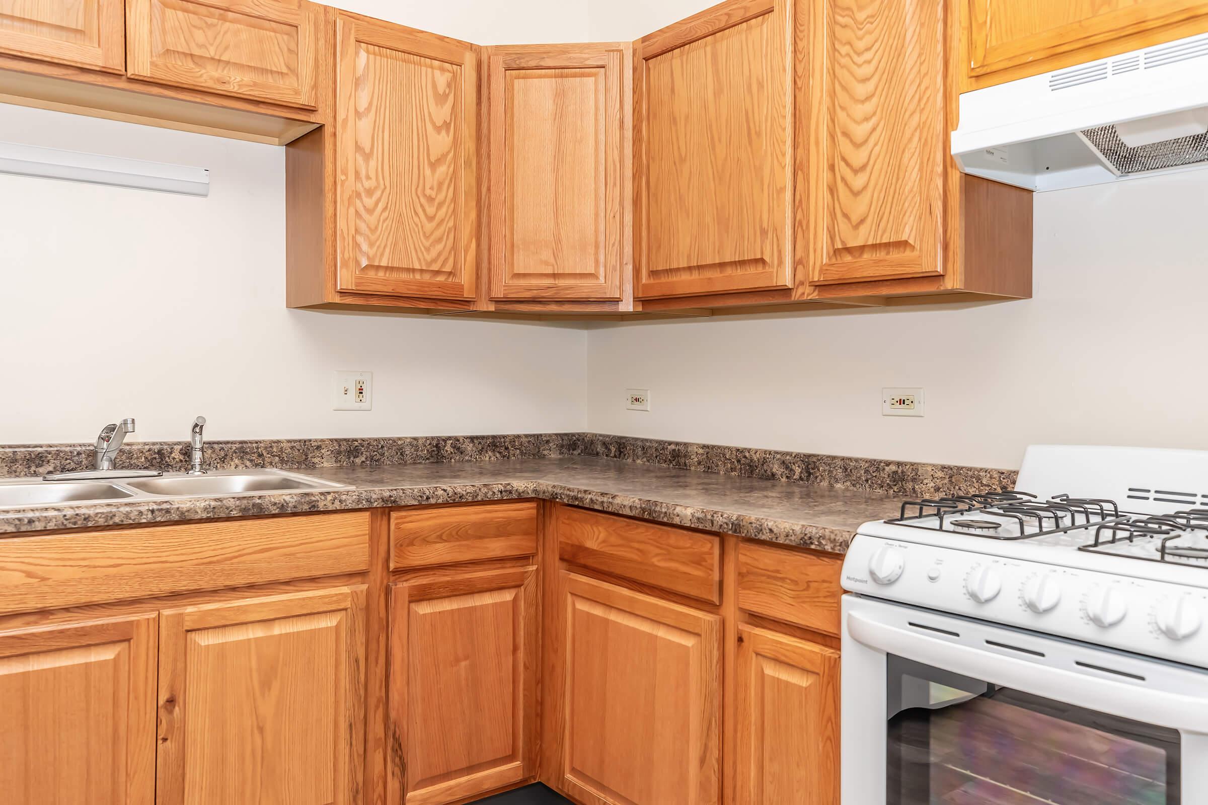 a kitchen with wooden cabinets and a microwave